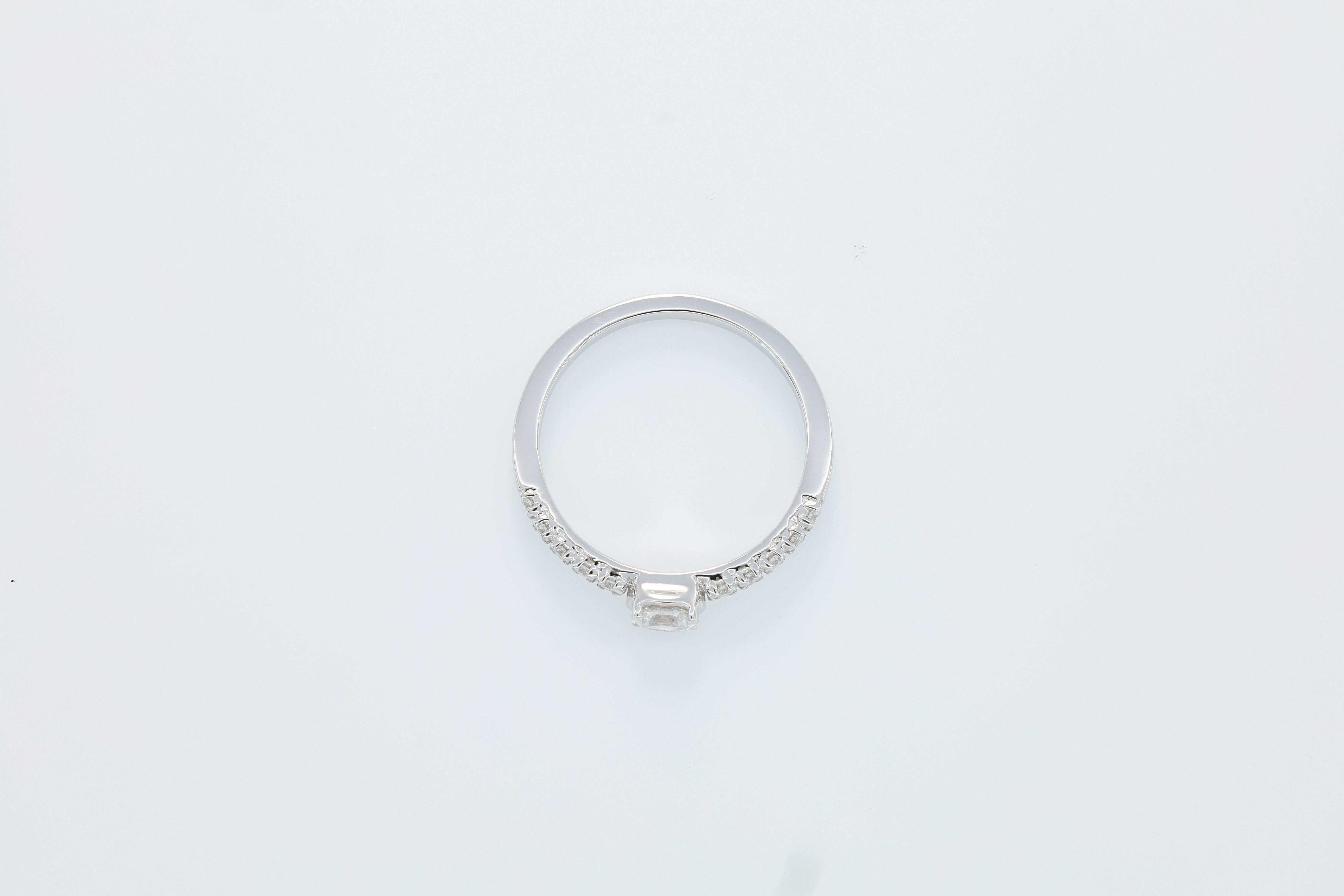 This exquisite masterpiece is a testament to timeless elegance and refined craftsmanship, making it the perfect choice for an engagement ring. At its heart lies a mesmerizing oval-shaped diamond, radiating brilliance and sophistication. Weighing