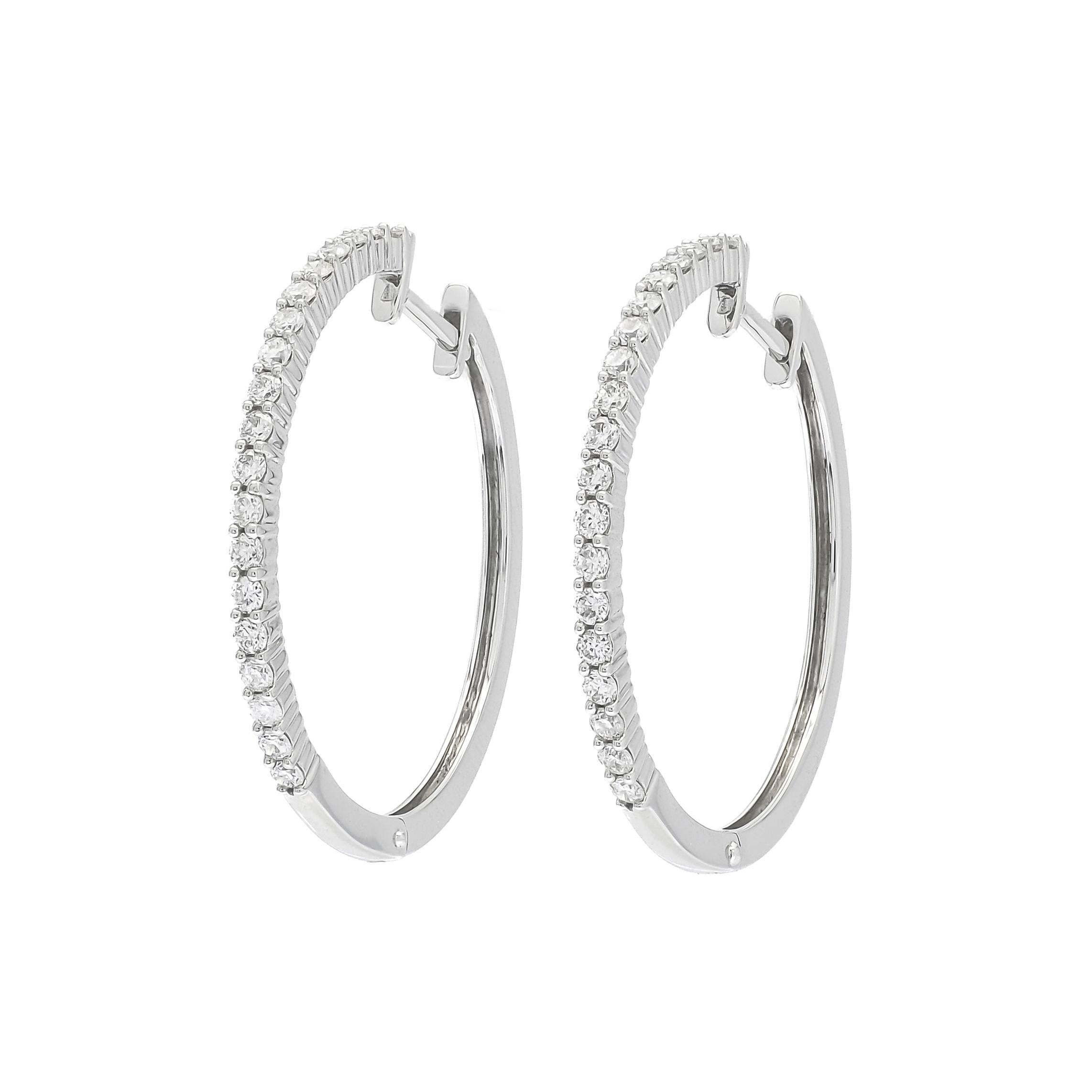 Introducing our extraordinary 18KT White Gold Single Row Diamond Hoop Earring! These stunning earrings are a testament to exquisite craftsmanship and timeless elegance. 

Each hoop is meticulously crafted from 18KT white gold, providing a lustrous