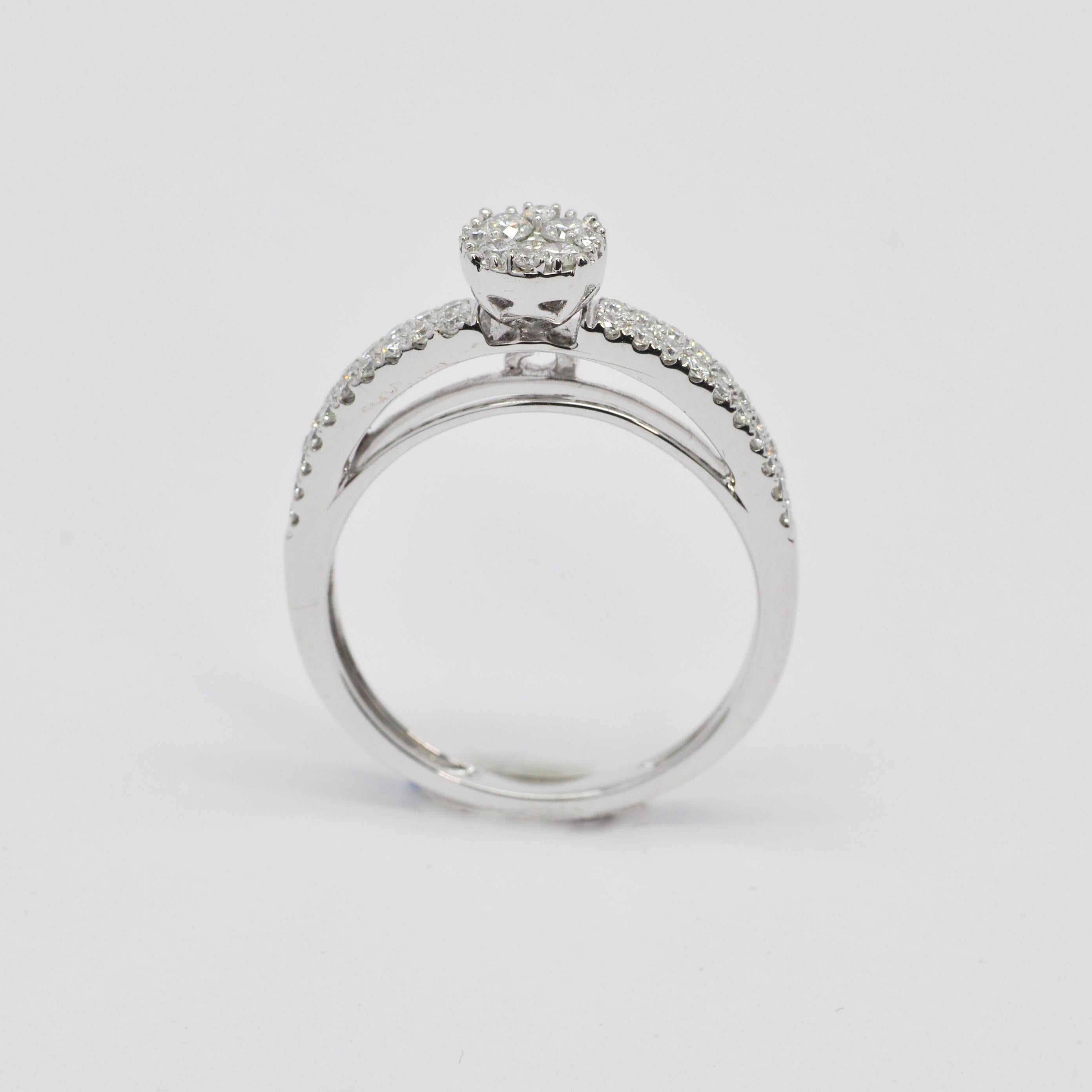 Experience the exquisite elegance of our Cathedral Peg Head Diamond Cluster Ring, a true masterpiece meticulously crafted in 18KT white gold. This ring features a stunning diamond cluster mounting, beautifully designed with decorative side accents