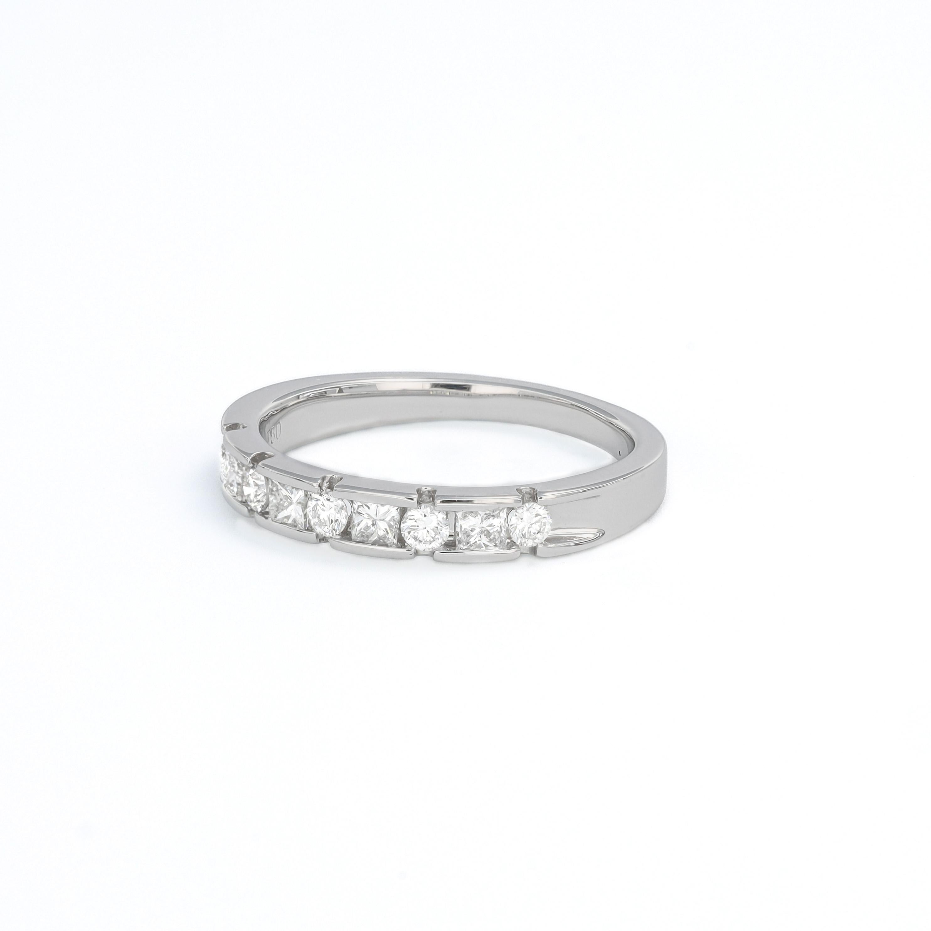 This 18K white gold Half-Eternity Ring is more than just a piece of jewelry; it symbolizes a love story that will last a lifetime. Crafted with a stunning combination of Princess and round natural diamonds, this ring totals 0.52 carats of