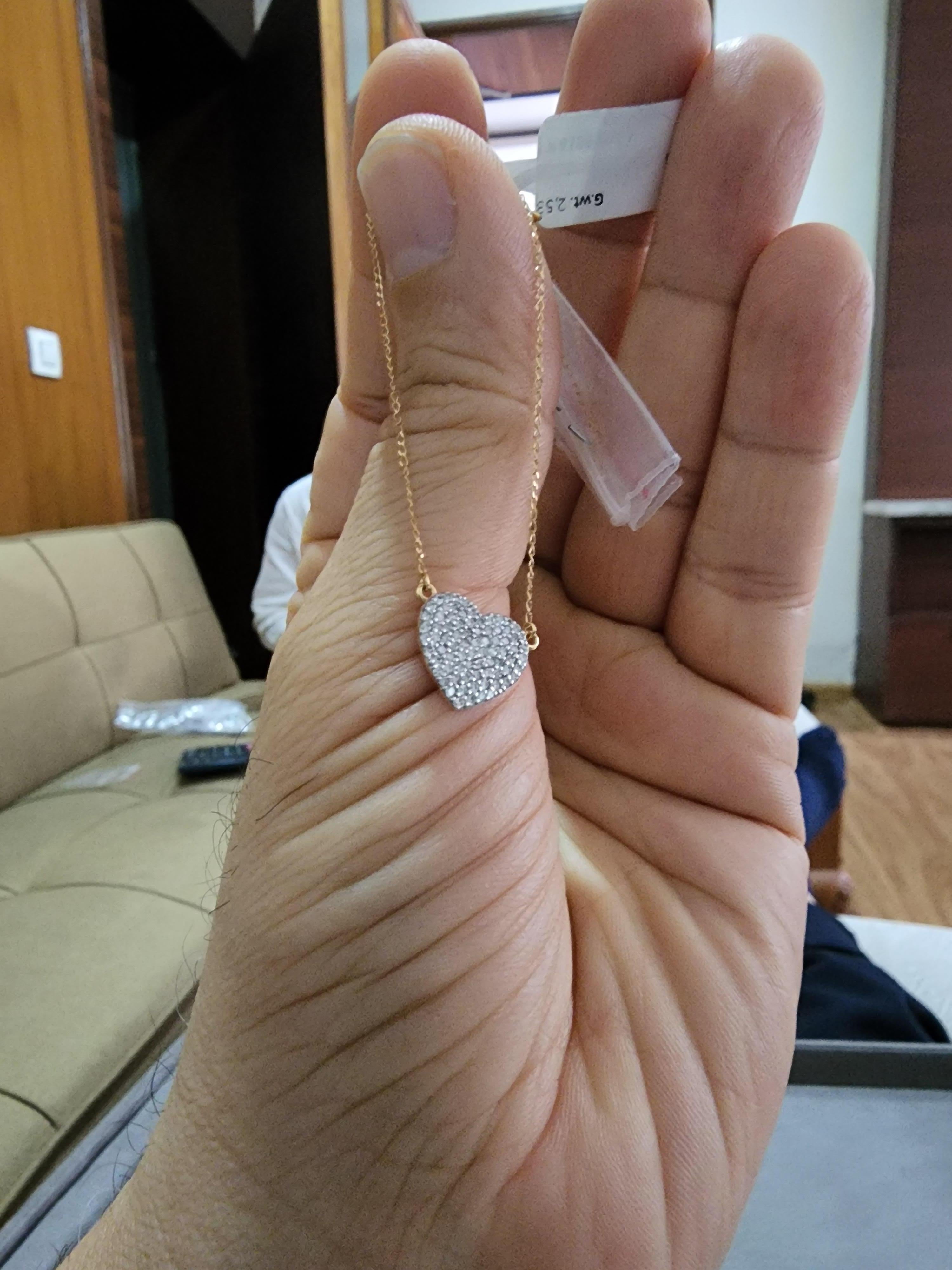 This is an amazing natural diamond pendant with 0.56 carats of white diamonds. Gold Weight is 2.42 gms (18k). Comes with a gold chain

It’s very hard to capture the true color and luster of the stone, I have tried to add pictures which are taken