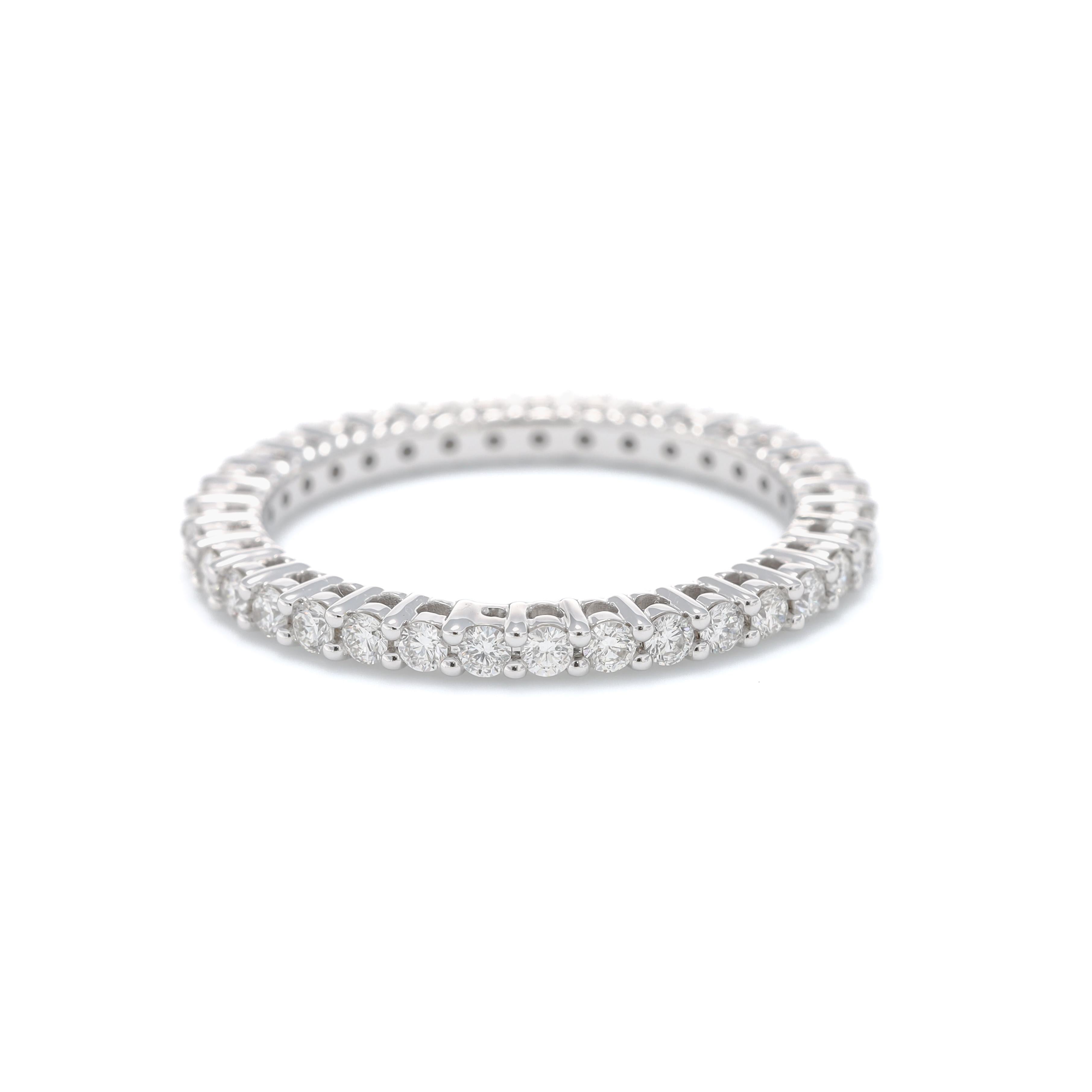 Indulge in the timeless allure of this exquisite diamond band, meticulously crafted from 18k White Gold to radiate elegance and sophistication. The band features a continuous row of round-shape diamonds, totaling 0.80 carats, set in a seamless and
