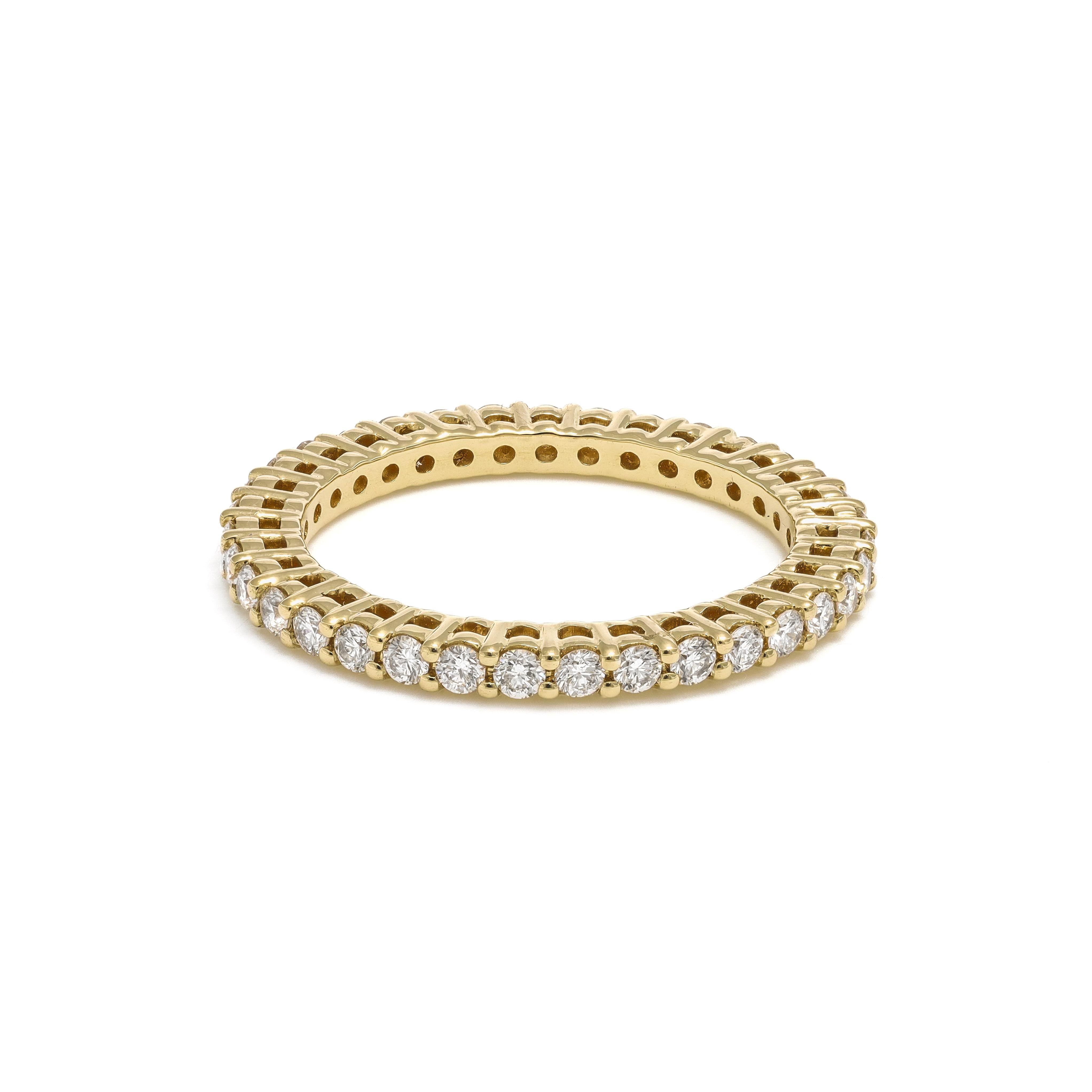 Indulge in the timeless allure of this exquisite diamond band, meticulously crafted from 18k Yellow Gold to radiate elegance and sophistication. The band features a continuous row of round-shape diamonds, totaling 0.80 carats, set in a seamless and
