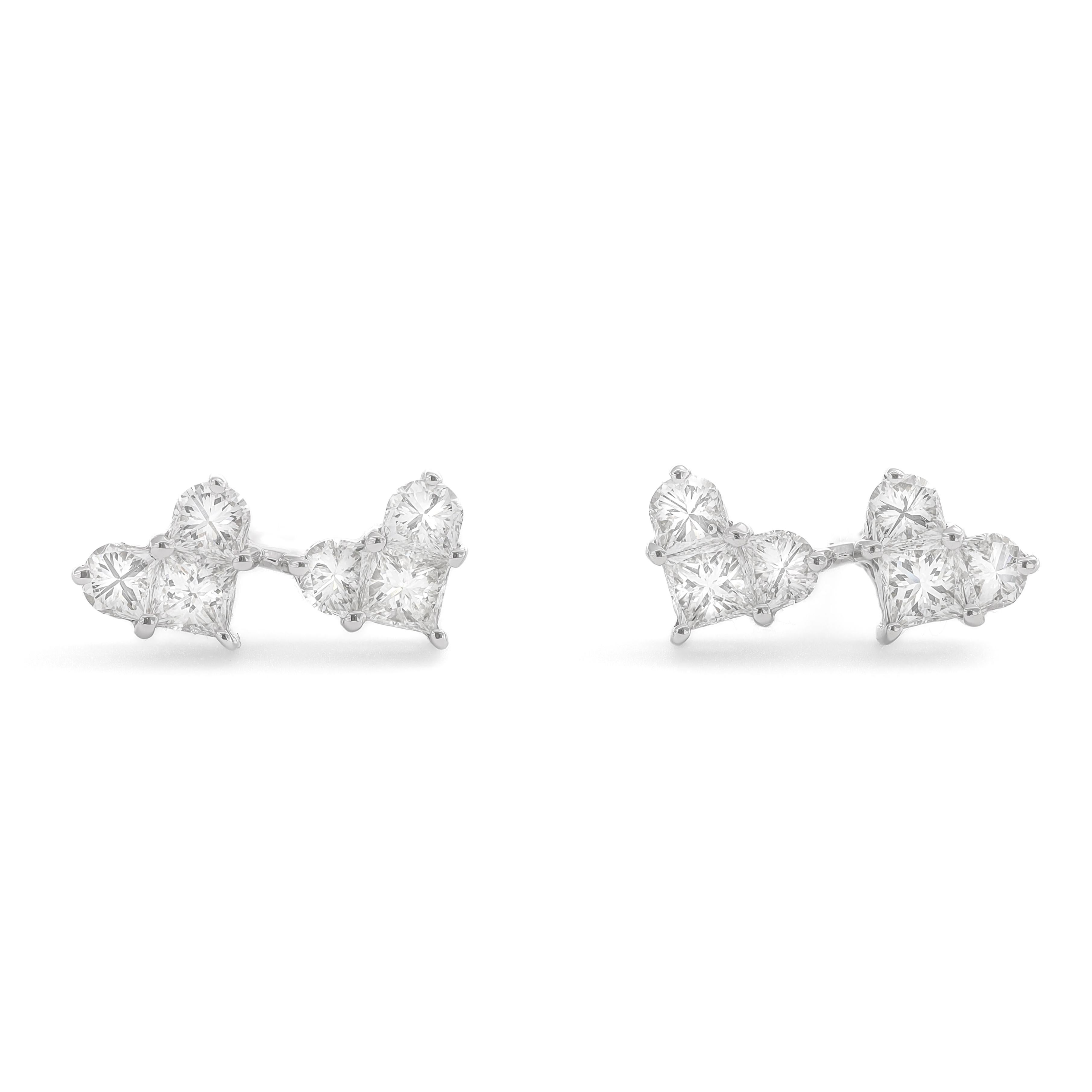 Impeccably crafted with meticulous precision, these stunning earrings boast a captivating design featuring a delicate cluster of two heart shapes, symbolizing love and unity. Each earring is adorned with a total of 0.85 carats of diamonds set in