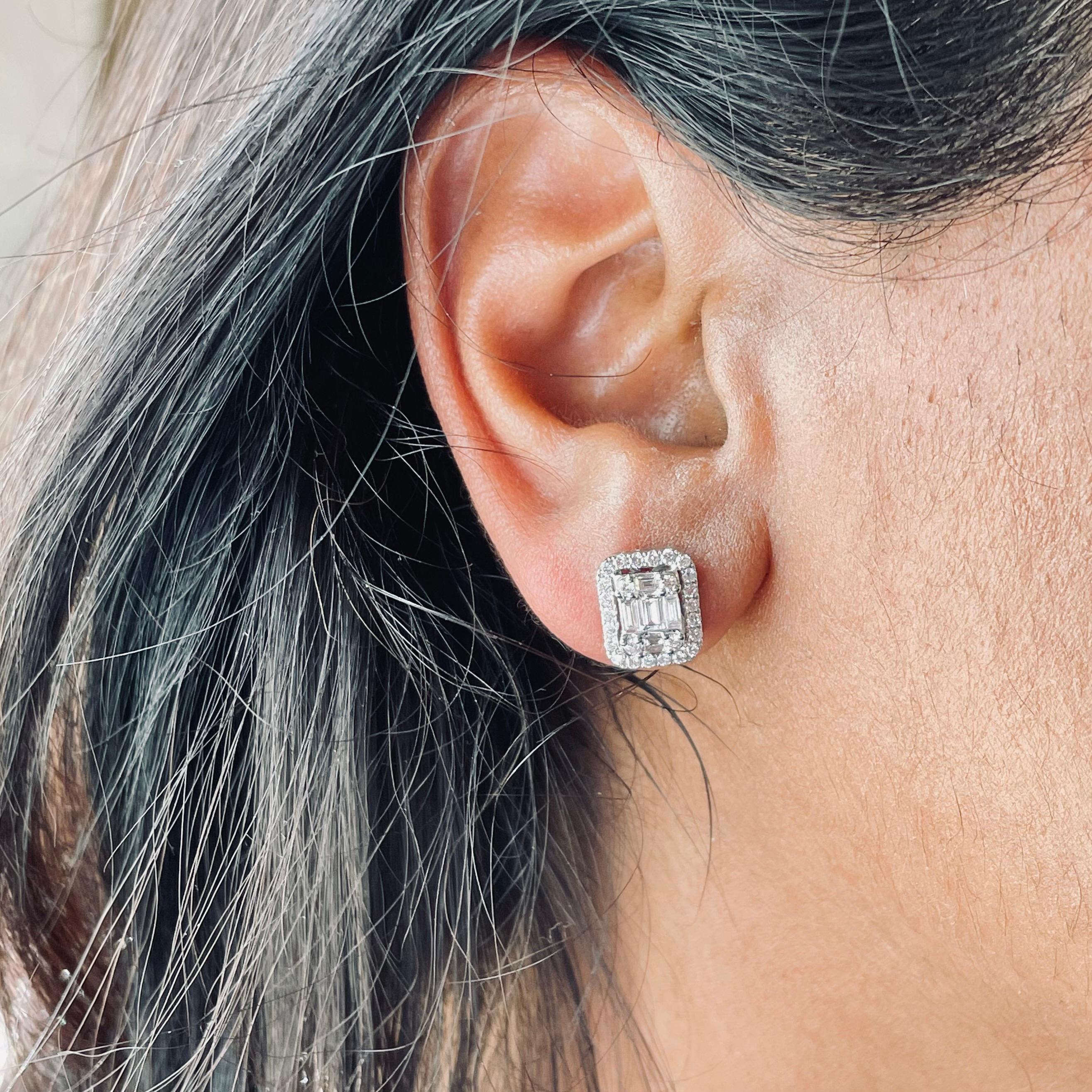 Introducing these luxurious 18KT White Gold stud earrings, a true masterpiece of elegance and craftsmanship. Each earring showcases a stunning diamond halo composed of natural diamonds, encircling a mesmerizing baguette-cut illusion cluster center.