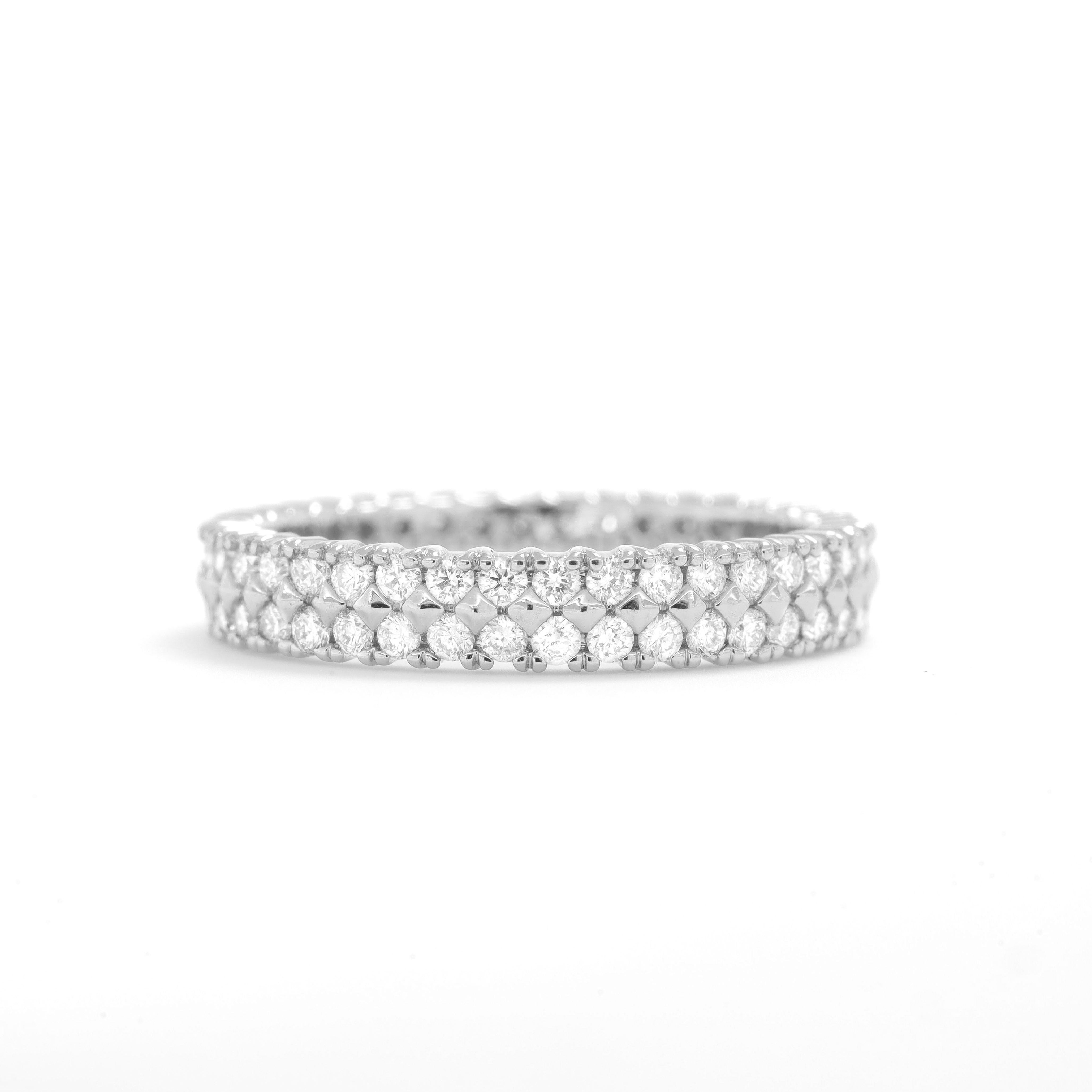 This captivating ring features a stunning double row of round diamonds totaling 1.00 carats, set in luxurious 18KT white gold. What truly distinguishes this piece is the artful incorporation of textured 18KT white gold beads, meticulously placed