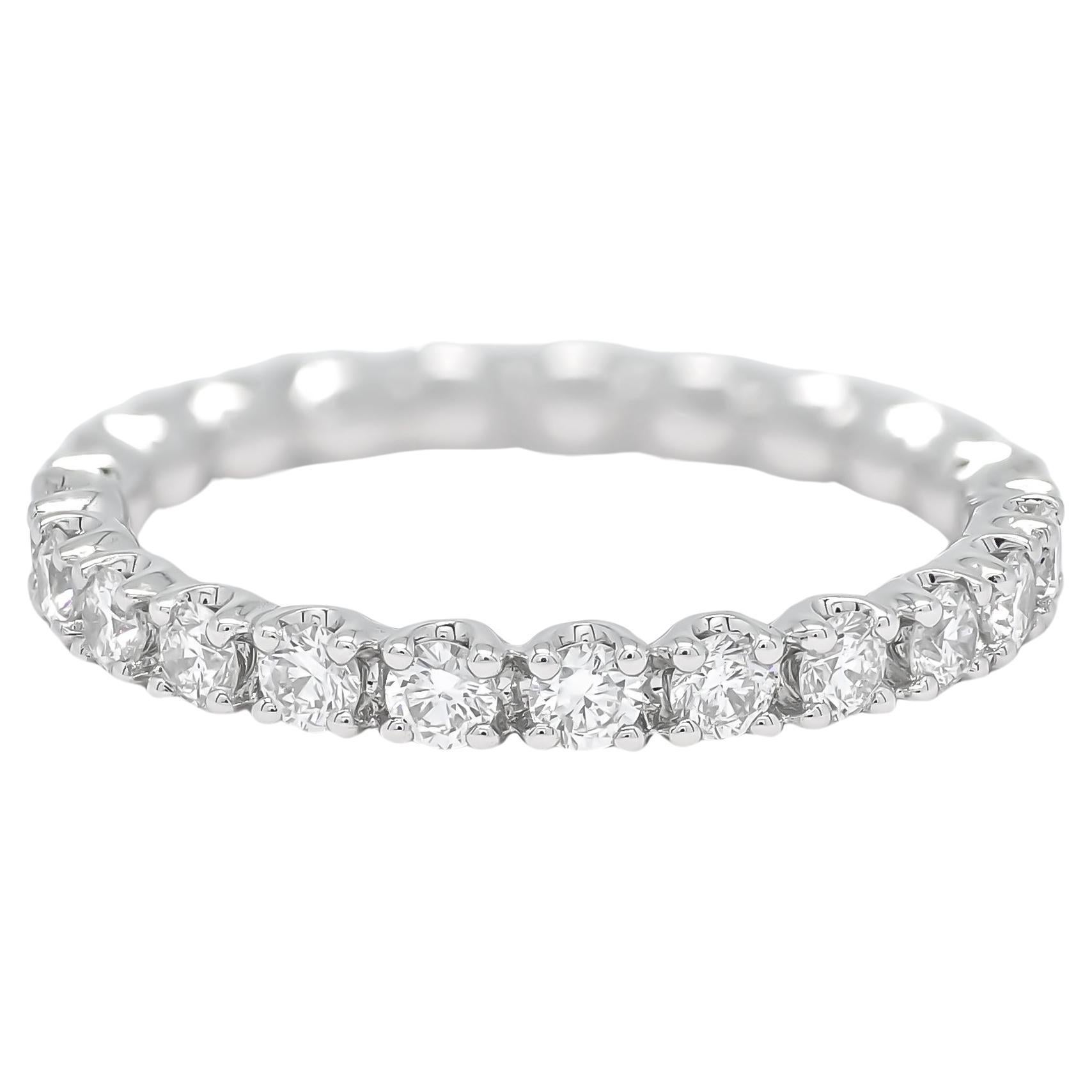 Adorn yourself in this delicate diamond band, a true masterpiece meticulously crafted from lustrous 18KT white gold. This extraordinary ring features a total of 1.06 carats of brilliant round-shaped diamonds,
elevating its classic appeal, this ring