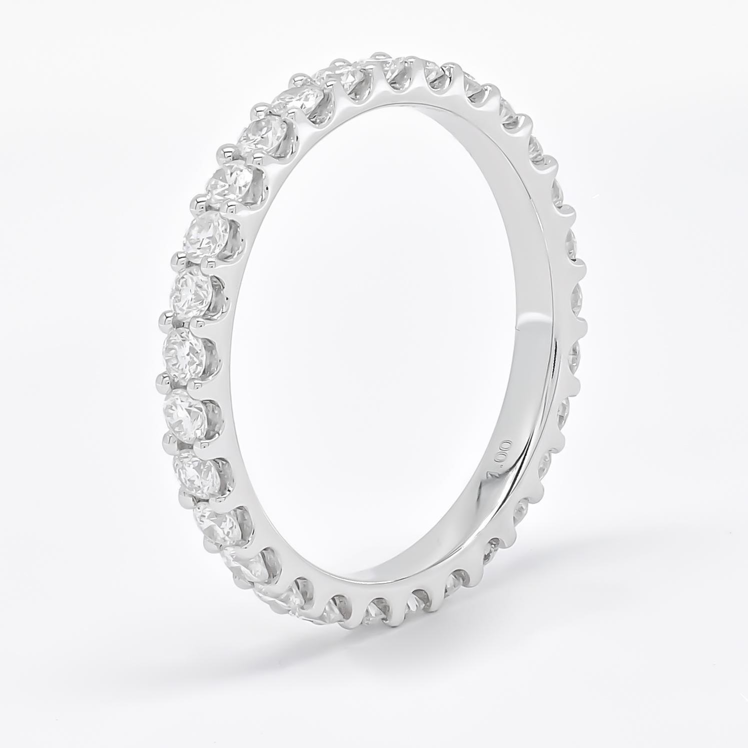 Experience the elegance of this exquisite diamond band, meticulously crafted in lustrous 18K White gold. Each detail of this band exudes sophistication and grace, featuring a continuous row of round-shaped diamonds set in a shared prong setting.