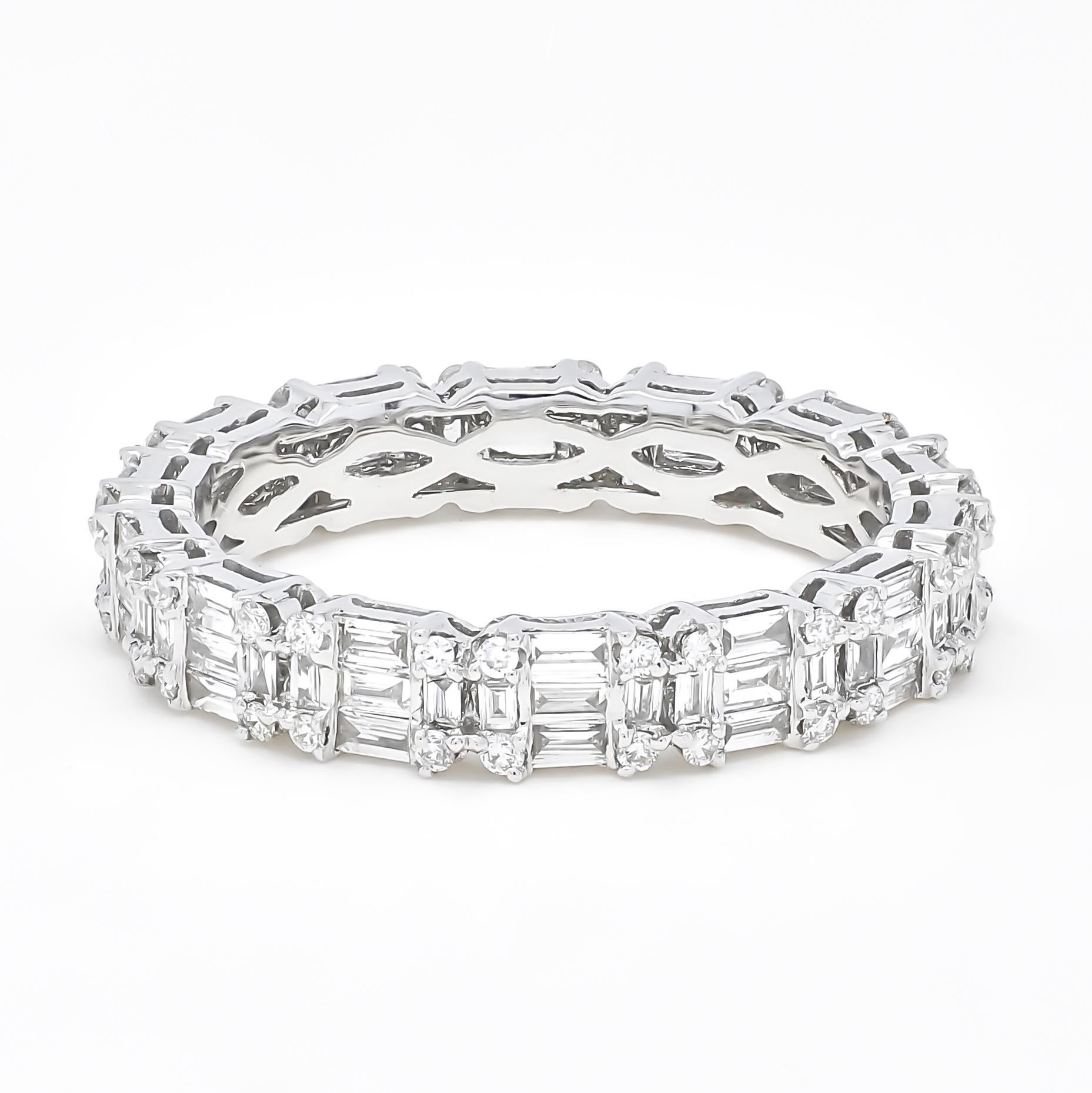 Crafted in luxurious 18KT white gold, this stunning band showcases a captivating combination of baguette and round-cut diamonds arranged in a unique cluster pattern. This intricate arrangement creates the enchanting illusion of larger solitaire