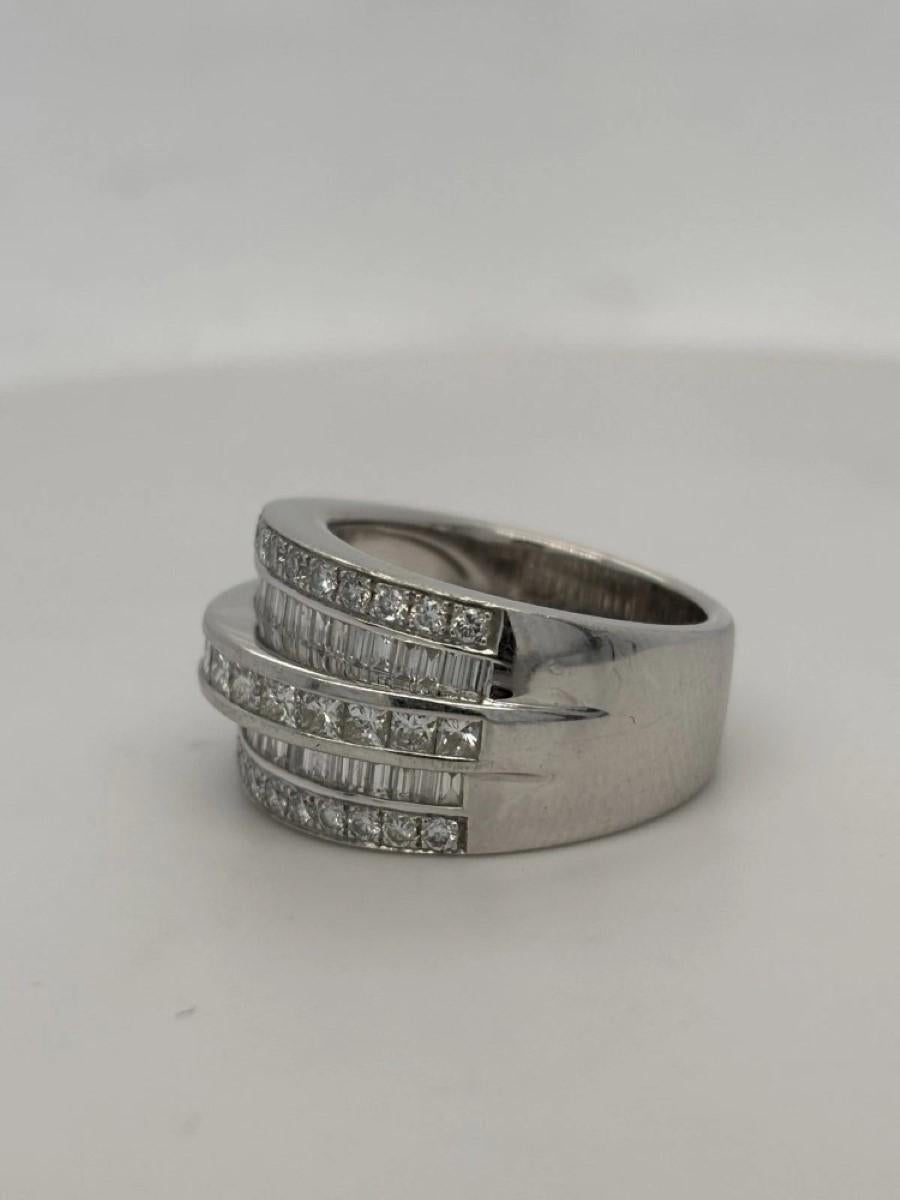Estate-wide band ring crafted in solid 14-karat gold, featuring three diamond cuts in a sophisticated mix of pave and channel settings. The ring contains approximately twenty-six (26) round brilliant cut diamonds, thirteen (13) princess cut