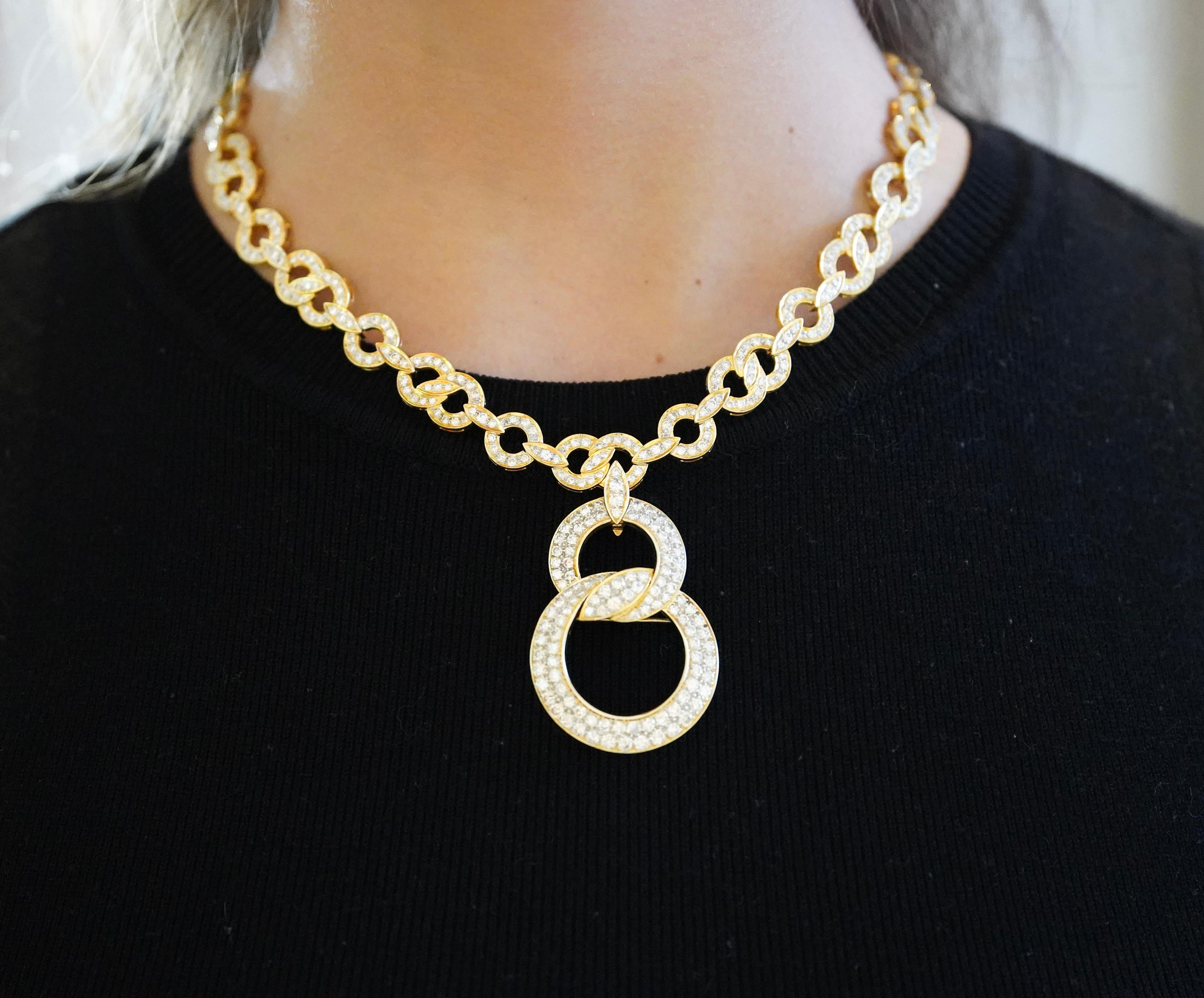Presenting a truly inspirational 18K yellow gold pendant necklace, featuring 16 carats of round-brilliant cut diamonds, secured in a pave set interlocking setting. The interlocking small (24mm) and large (33mm) circles create a captivating piece