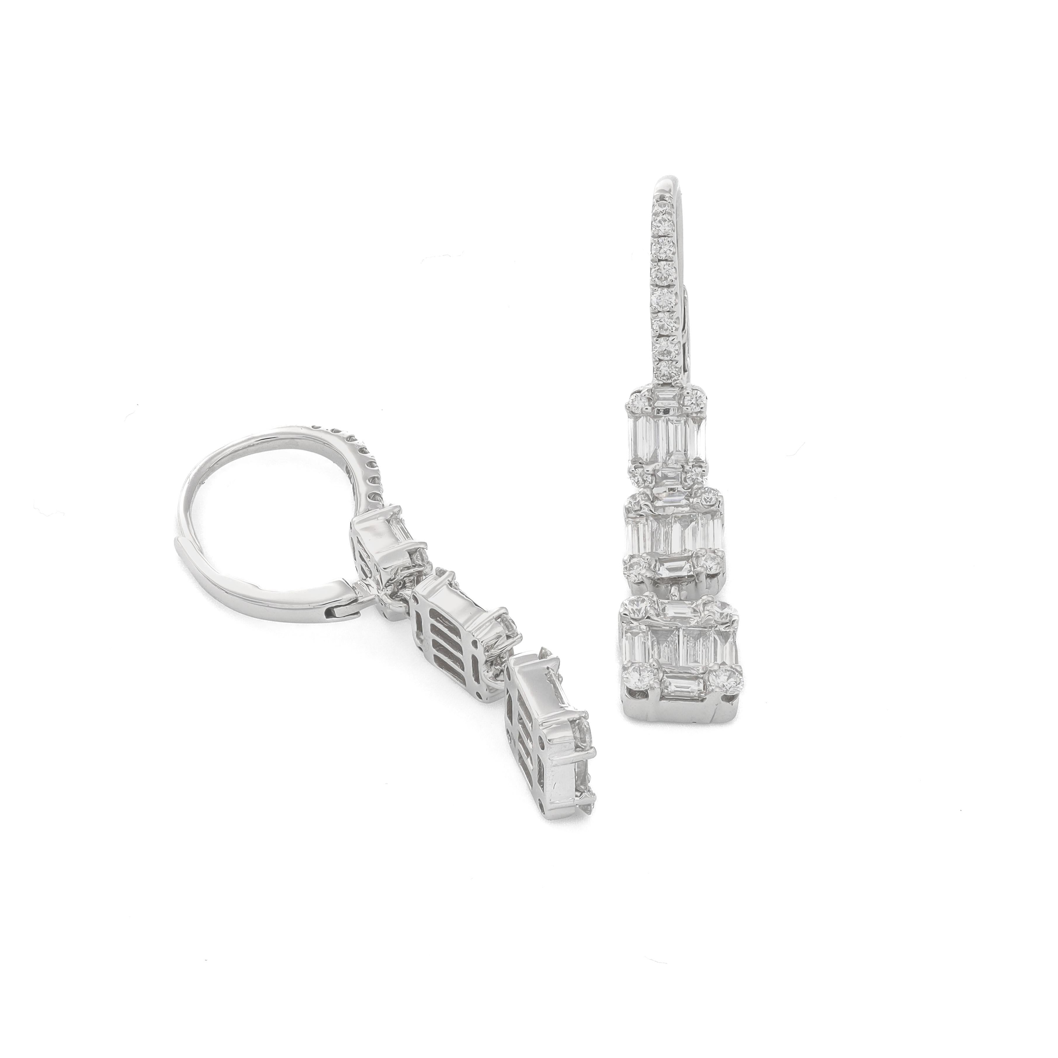 Immerse yourself in the captivating allure of the 18KT White Gold Baguette and Round 3 Cluster Drop Dangler Earring, a true masterpiece of jewelry artistry designed to enchant women of all ages. Each element of these earrings has been crafted with