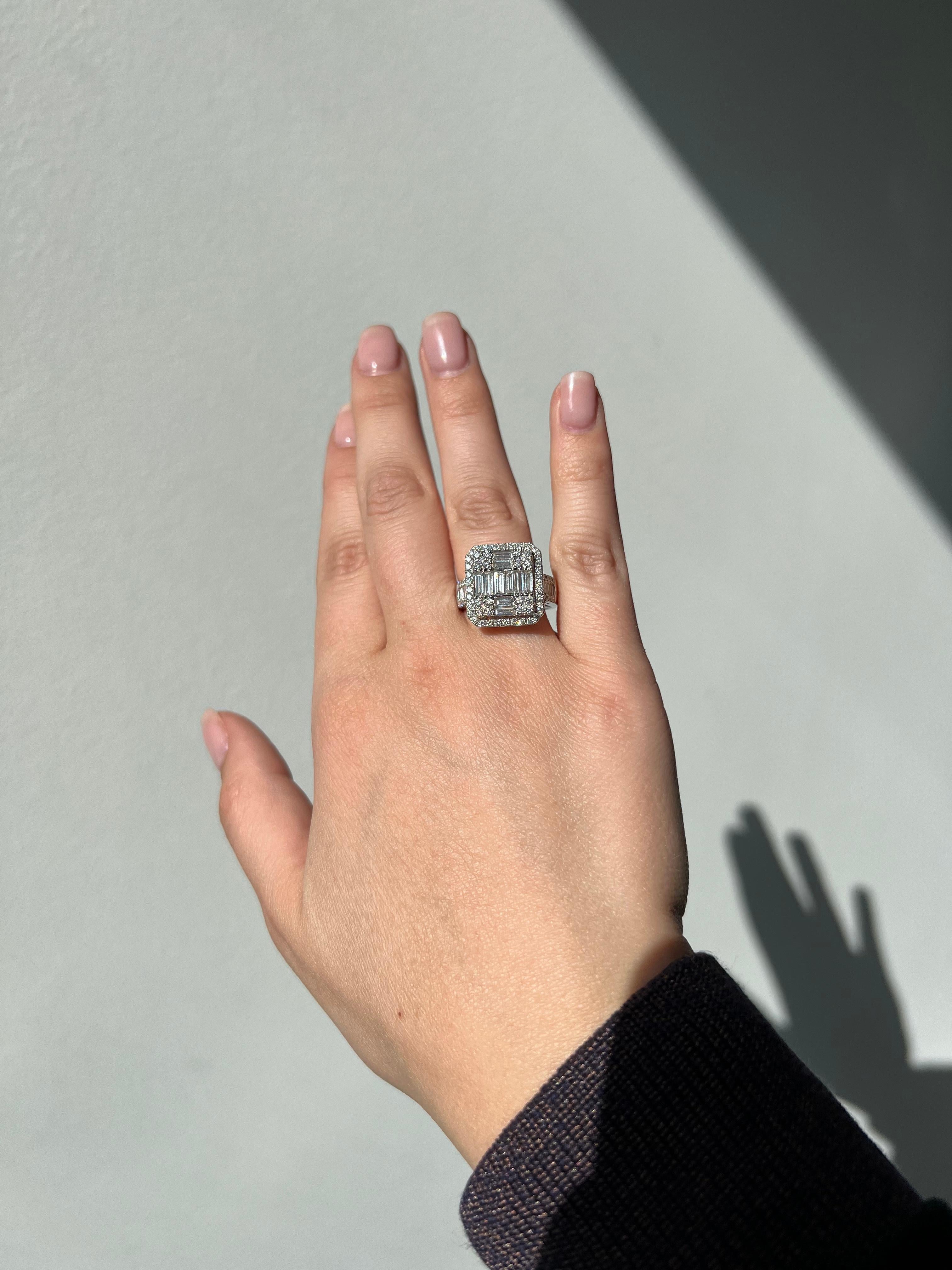 This 18KT white gold cocktail ring is perfect for any party outfit! With its sparkling baguette, round diamond cluster halo, and side accent stones, it's sure to turn heads. But don't let the party end there - this ring is also perfect for adding a