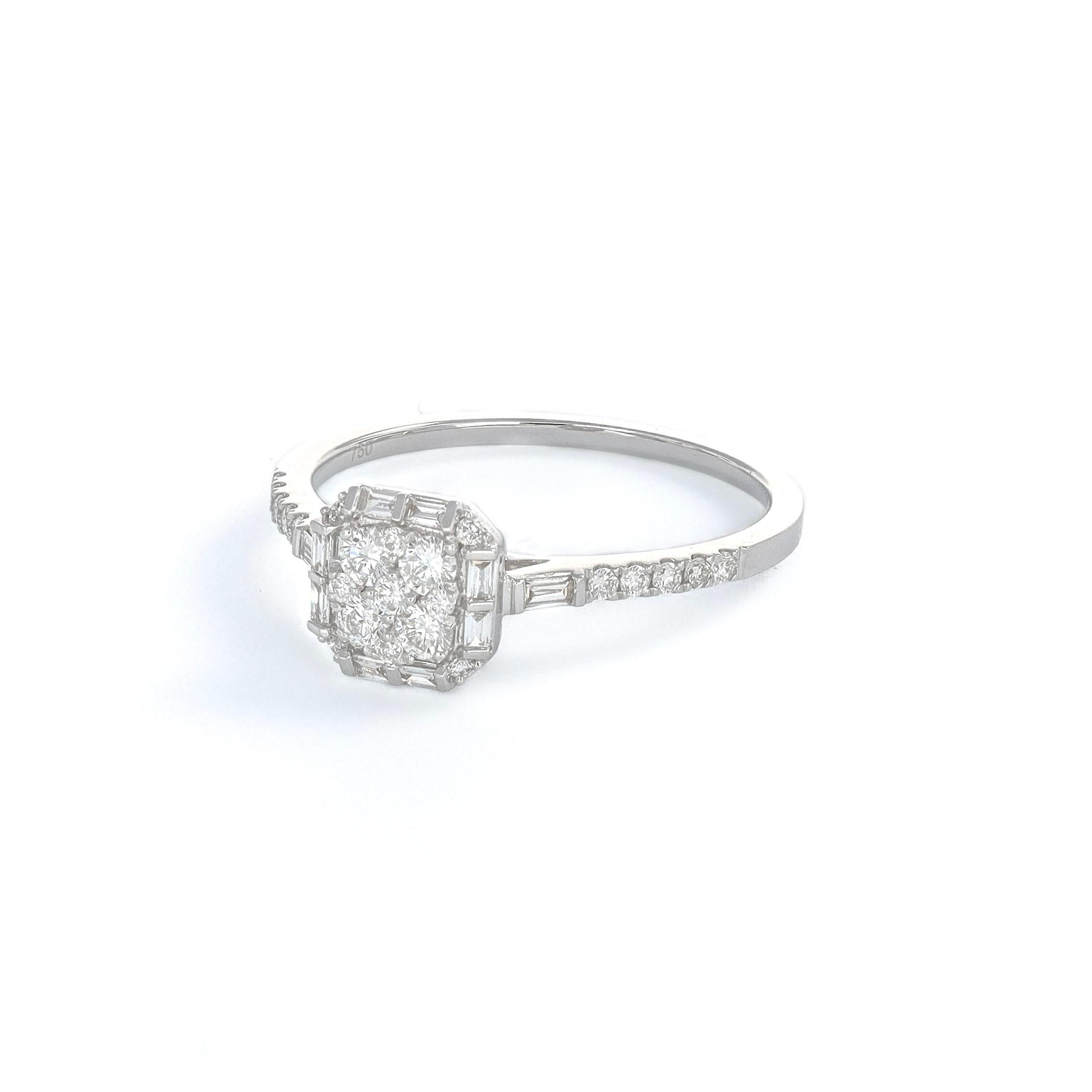 This 18KT White Gold Art Deco Baguette Round Diamond Illusion Ring is luxurious and elegant. The intricate design features a mesmerizing illusion step cut, showcasing the sparkling round diamonds in a stunning baguette setting. 

The white gold band