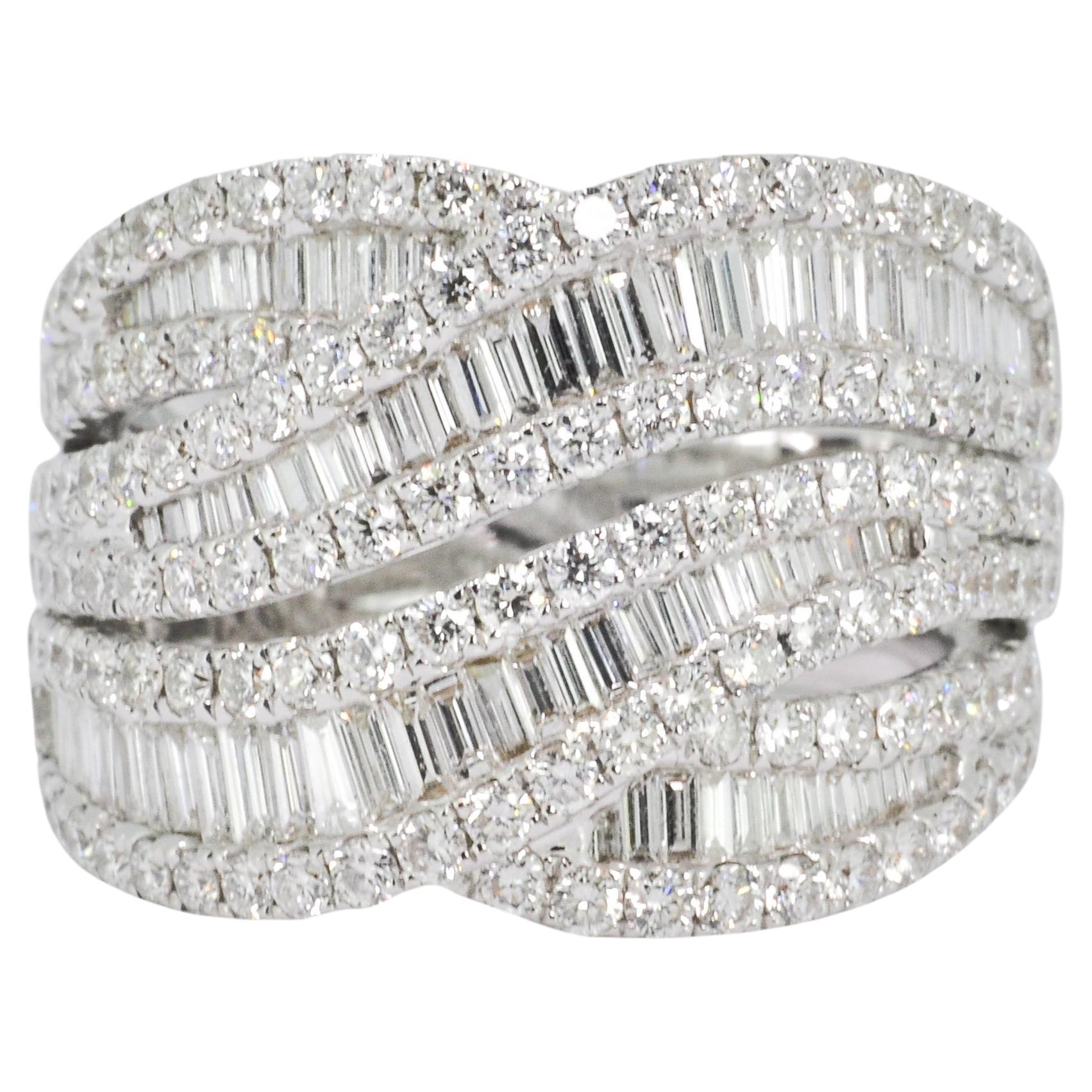 Bold Geometric Settings of Round and Baguette Diamonds Impart Light-Catching Sparkle From Every Angle of This Statement-Making White Gold Ring. 

This design imparts a sinuous shape to the ring, which is further enhanced by the dynamic sparkle of