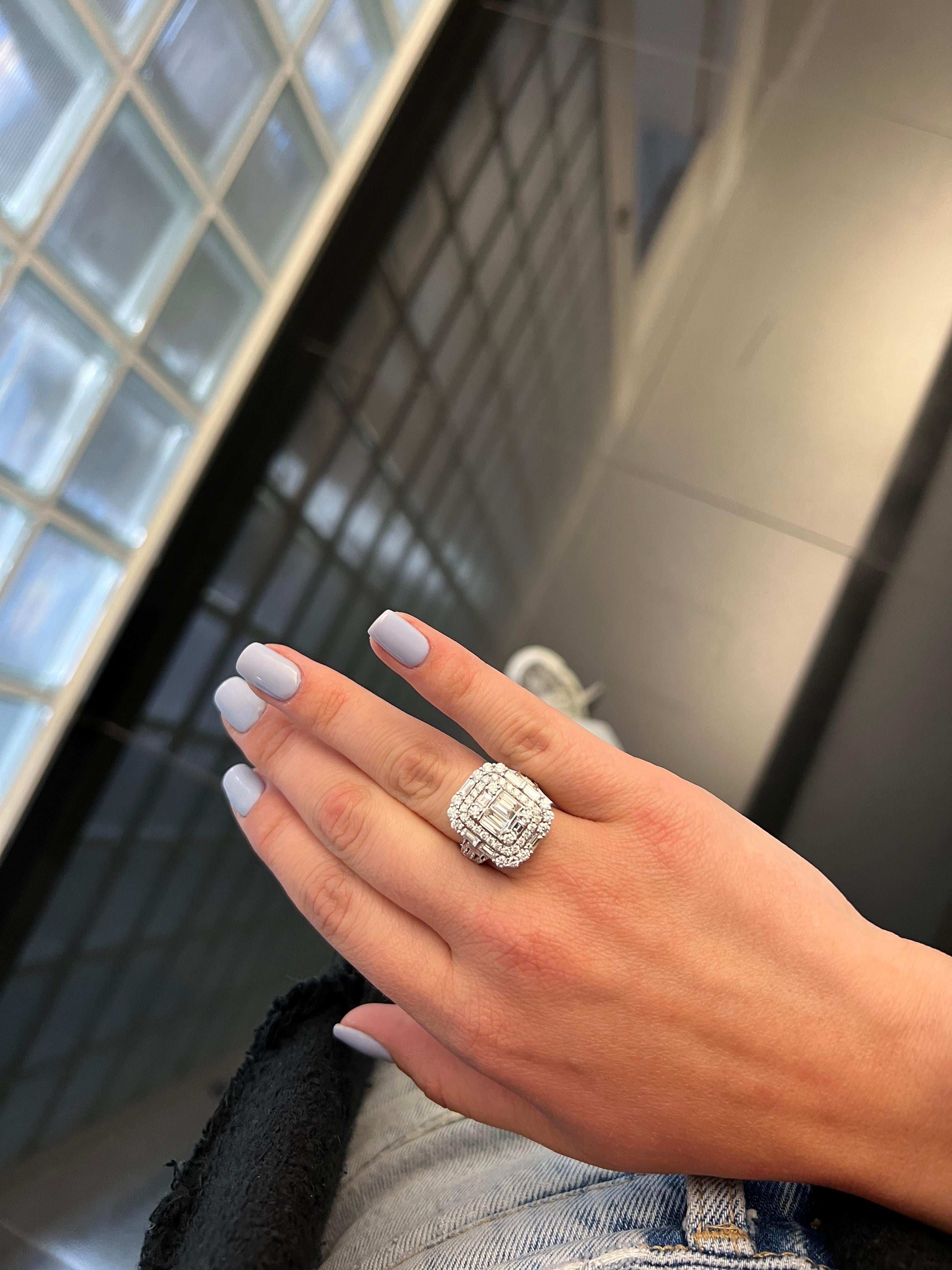 The Natural Diamond Ring in 18KT White Gold is a stunning cocktail ring that showcases the timeless beauty of diamonds. With its Art Deco inspired design, featuring a cluster of baguette and round diamonds, this ring is sure to make a statement.