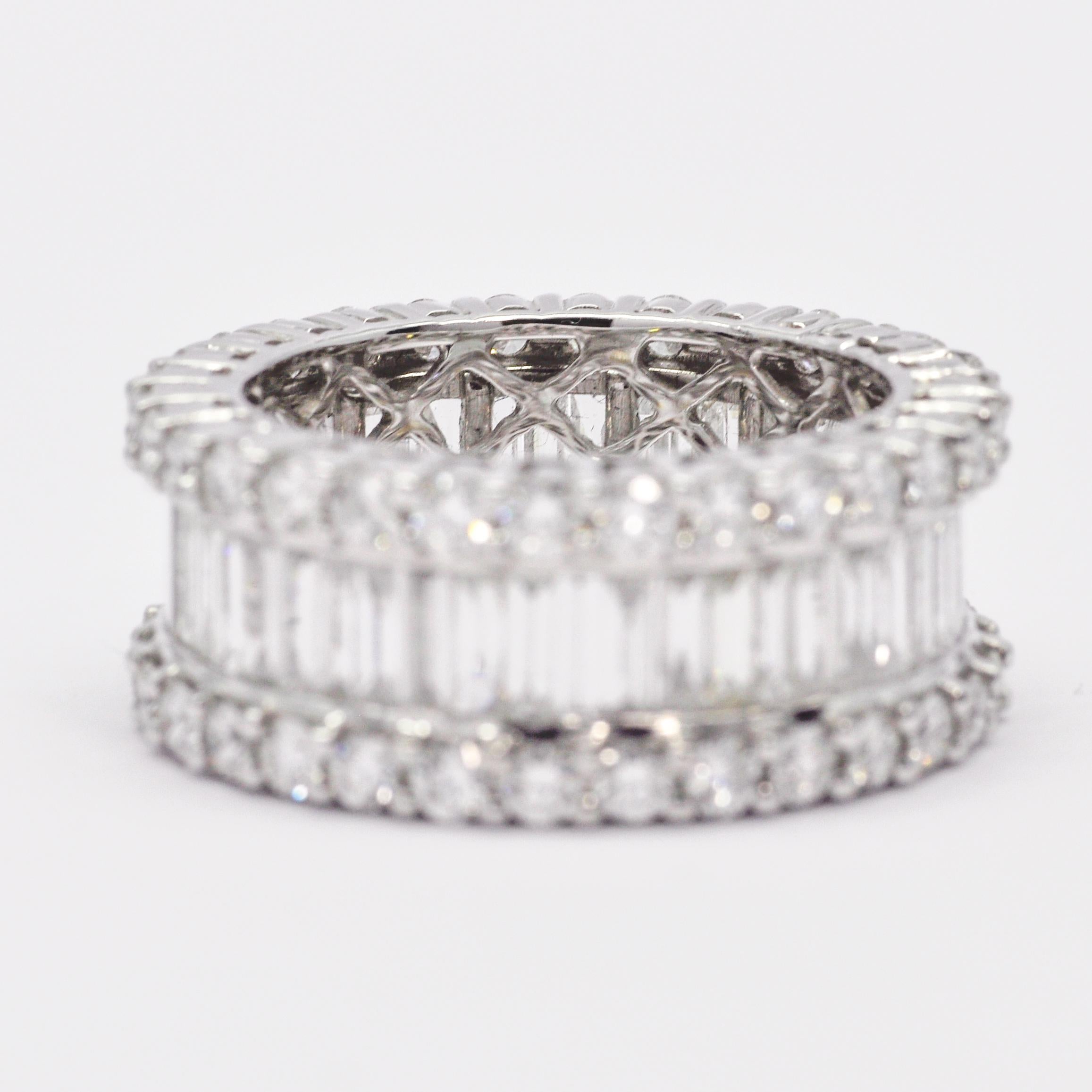 An elegant row of baguette diamonds gleams brightly amidst two rows of round-shape diamonds in this extraordinary band.

A modern masterpiece, this striking band features a curved arch of brilliant baguettes bordered by stunning round-shape