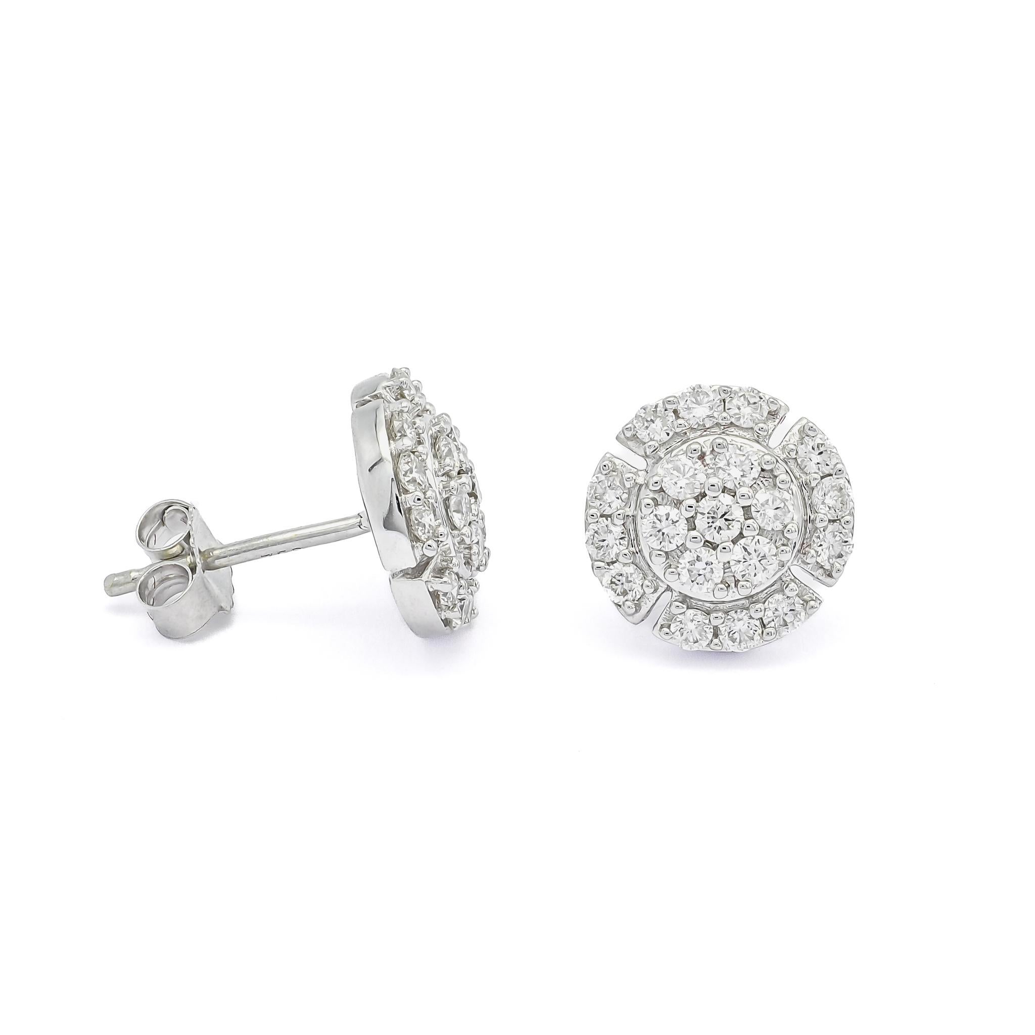 The enchanting halo design surrounding the small round cluster  adds an ethereal dimension to these earrings. Nestled at the heart of these earrings, a captivating flower-shaped cluster of diamonds adds a breathtaking touch of nature-inspired