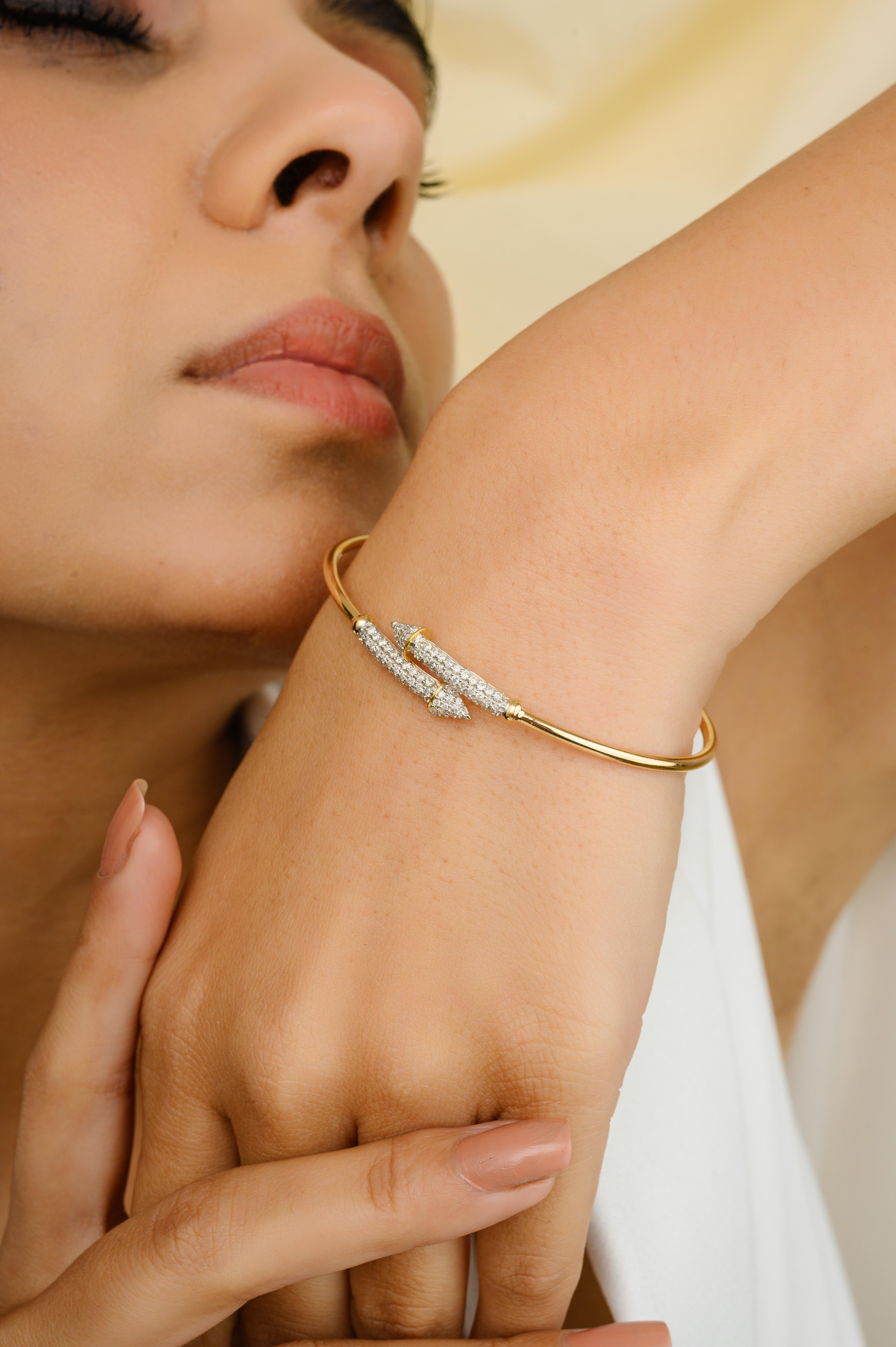 This Natural Diamond Arrow Open Cuff Bangle Bracelet for Women in 18k Yellow Gold showcases endlessly sparkling natural diamonds weighing 0.6 carat. It is adjustable in length. 
Designed with perfect round diamond cut set in pave setting on bangle