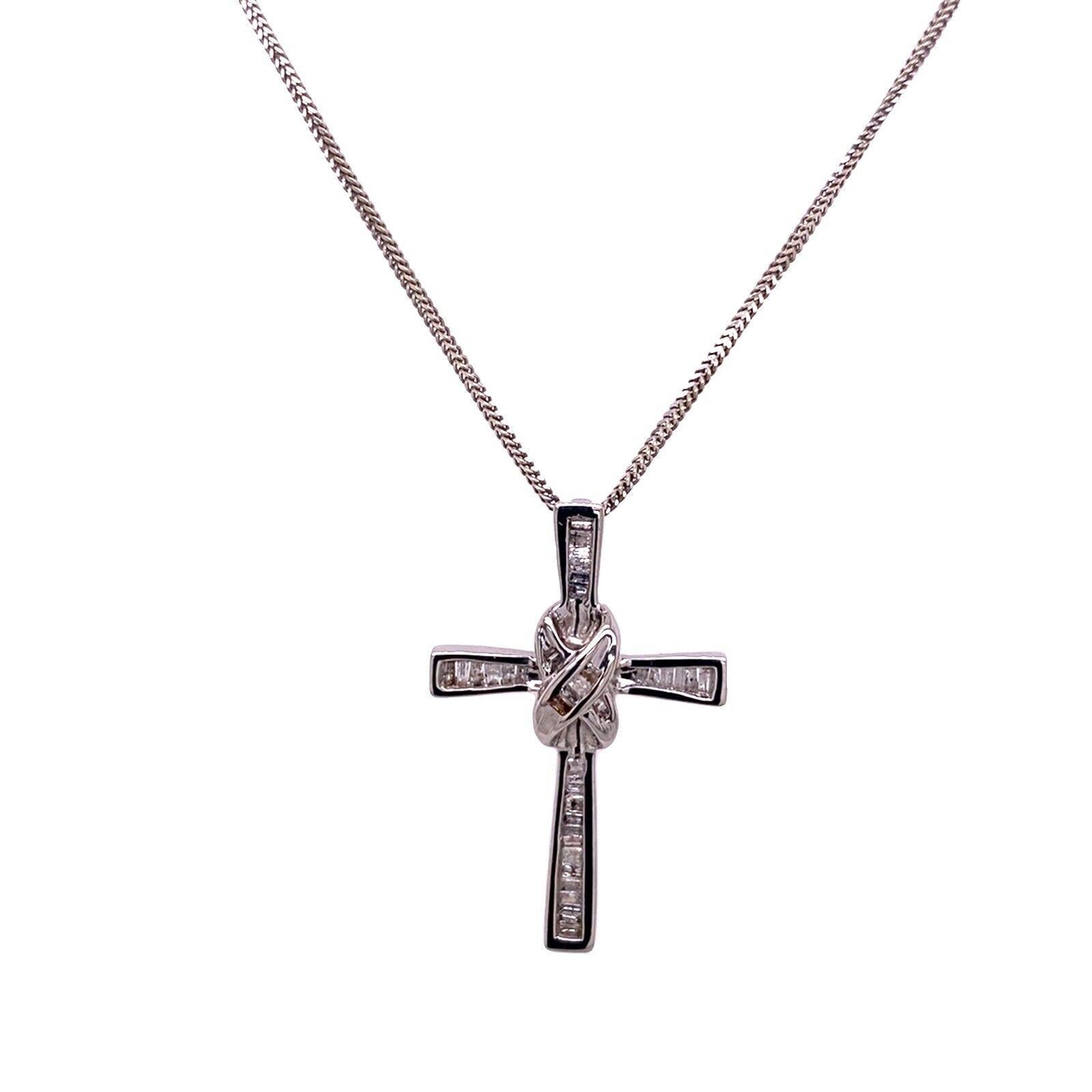 This delicate 14ct white gold diamond cross,features a 0.50ct G-H/I baguette diamonds, suspended on 18ct white gold foxtail chain, 16