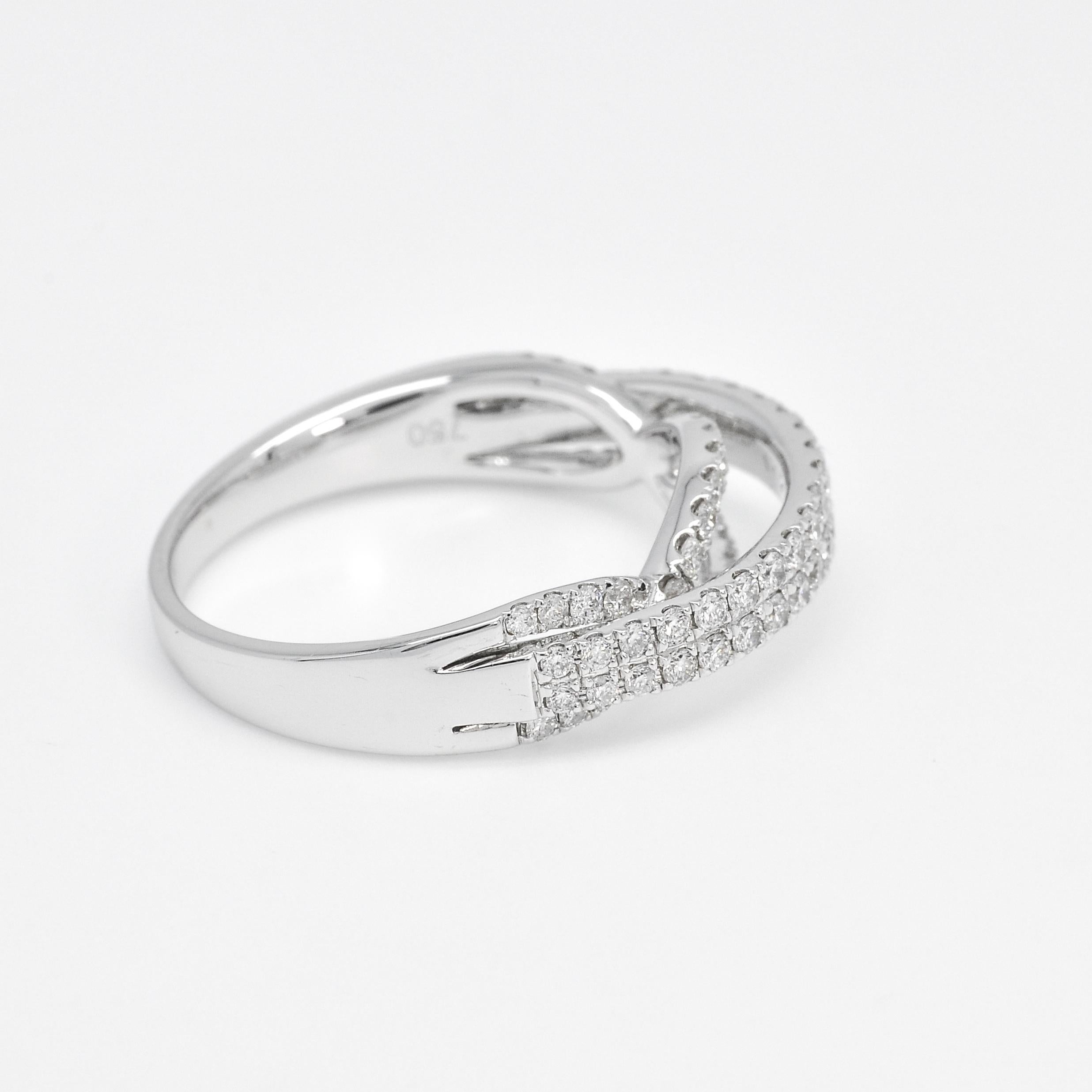 A multi-row diamond band in 18 Kt white gold with a pave setting is an exquisite and elegant gift idea for anniversaries and weddings. This beautiful ring features multiple rows of brilliant diamonds that are set closely together in a pave style,