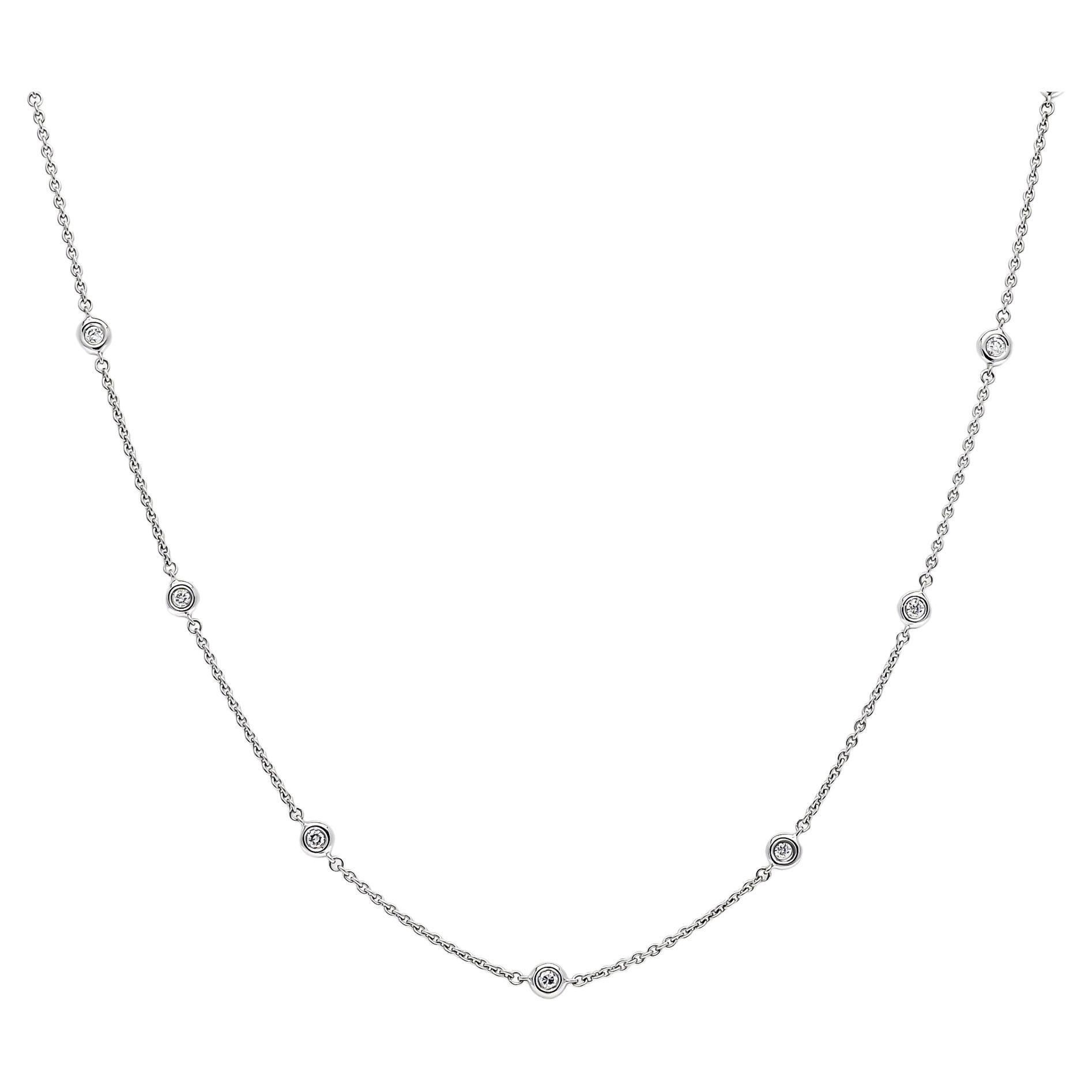 Indulge in the epitome of luxury with our Dazzling Diamond Sparkle, captured with unparalleled elegance and enchantment in an 18 Karat White Gold Bezel Set Chain Necklace. This extraordinary piece showcases a resplendent round-cut diamond, weighing