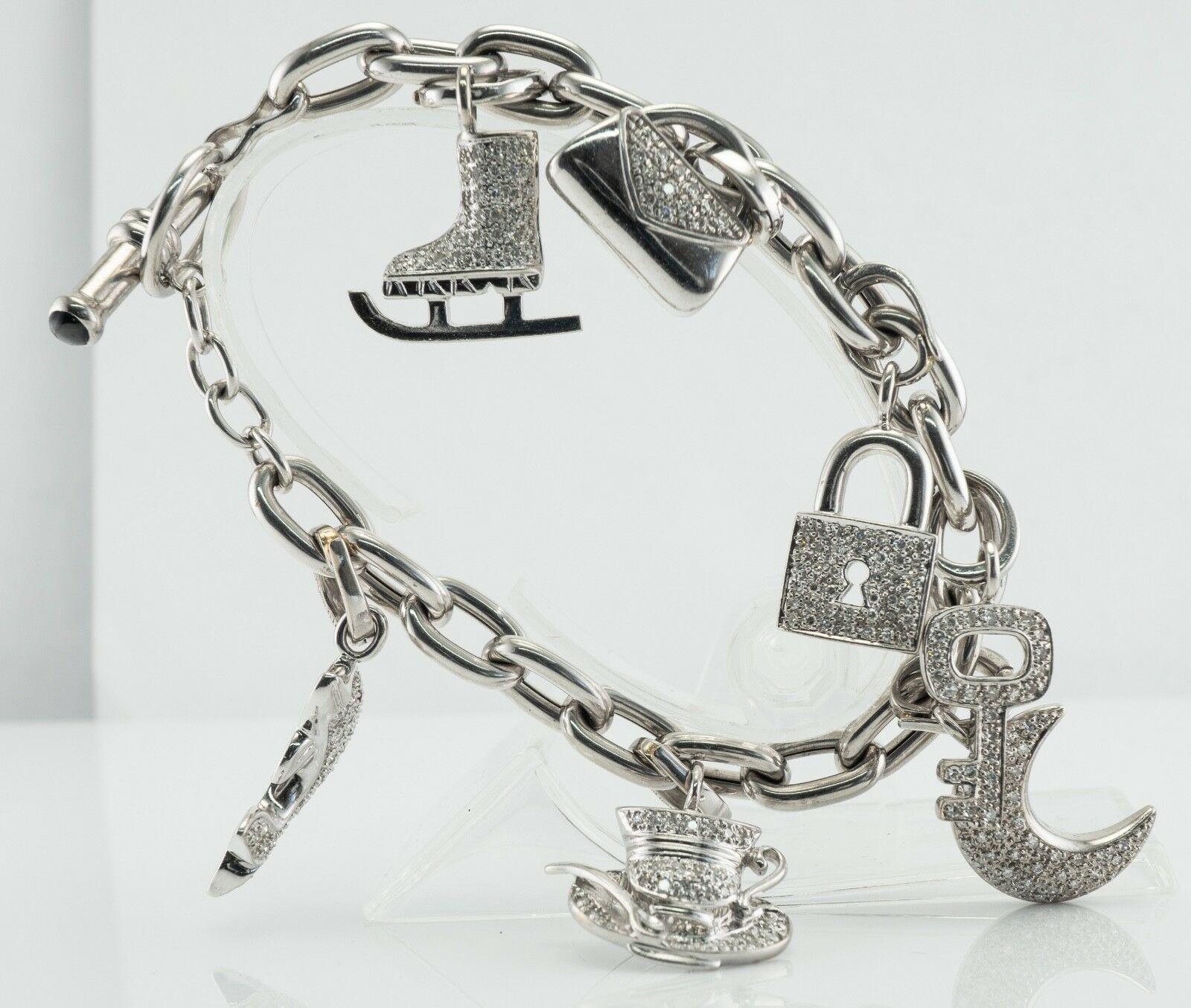 Natural Diamond Charm Bracelet 18K White Gold 3.45 TDW

This amazing multi- charm diamond bracelet has been made in Italy. 
The chunky chain is made in solid 18K White Gold and all charms are solid 14K White Gold. 
There are seven charms depicting