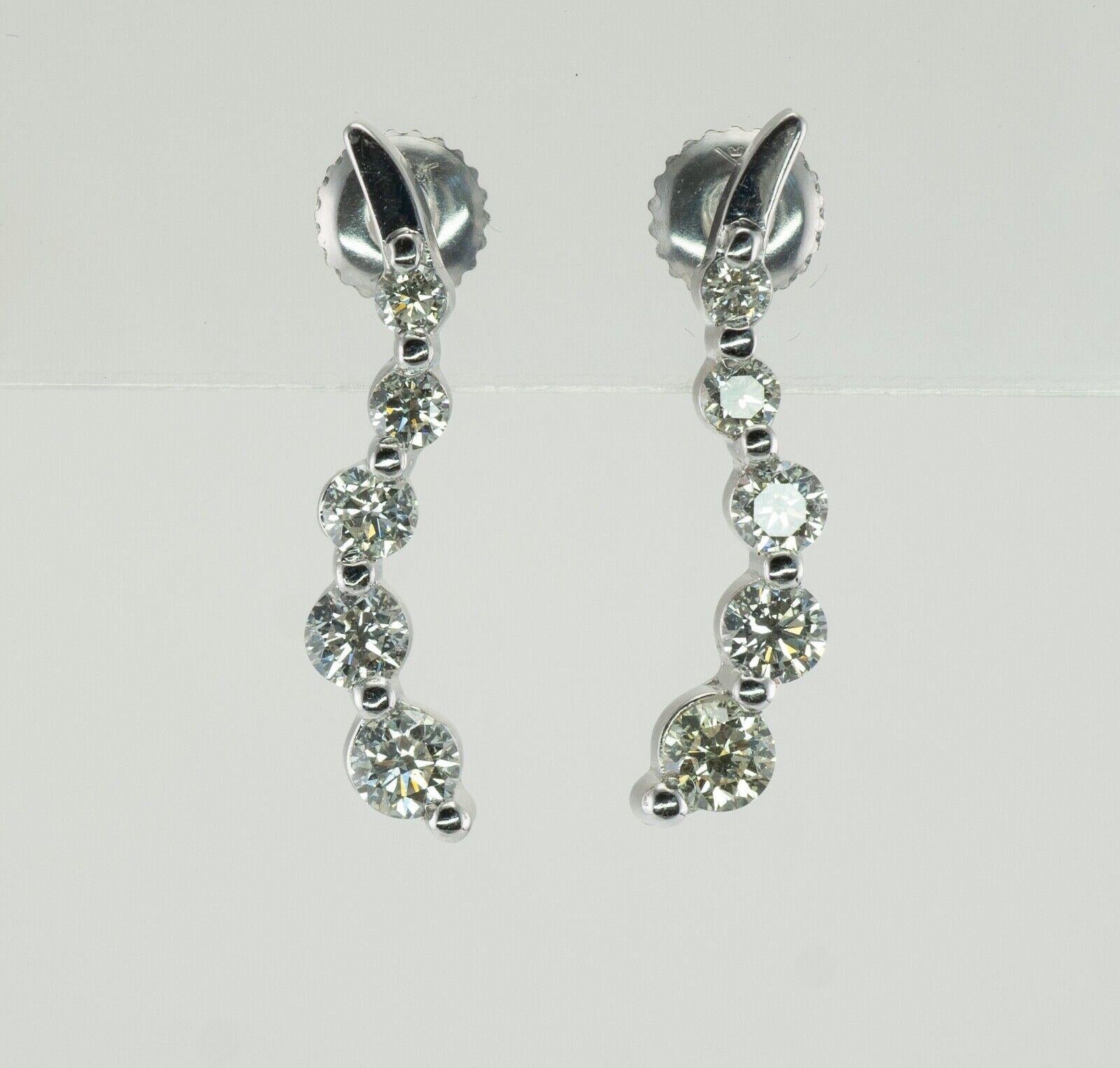 Natural Diamond Earrings 14K White Gold Dangle Bubbles

These beautiful and unusual earrings are finely crafted in solid 14K Wjote Gold (carefully tested and guaranteed). There are five diamonds in each earring. They graduate from .07 carat to .25