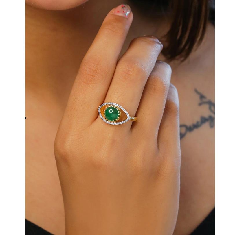 This ring is made of 14K yellow gold and set with an emerald gemstone in the shape of an evil eye. The ring is pave set with diamonds for a dazzling look.

Specifications

Dimensions: Length: 1.1 cm, Width: 1.8 cm
Gross Weight: 4.430 gms
Gold