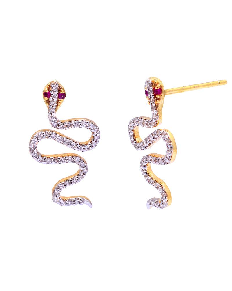 

Handcrafted in 14K Solid Yellow Gold 0.45 Carat Natural Diamond (G-H Color, SI1-SI2 Purity) and Ruby Gemstone, these earrings bring simple elegance and shine to face of the wearer. The serpentine design is perfect with summer dresses and