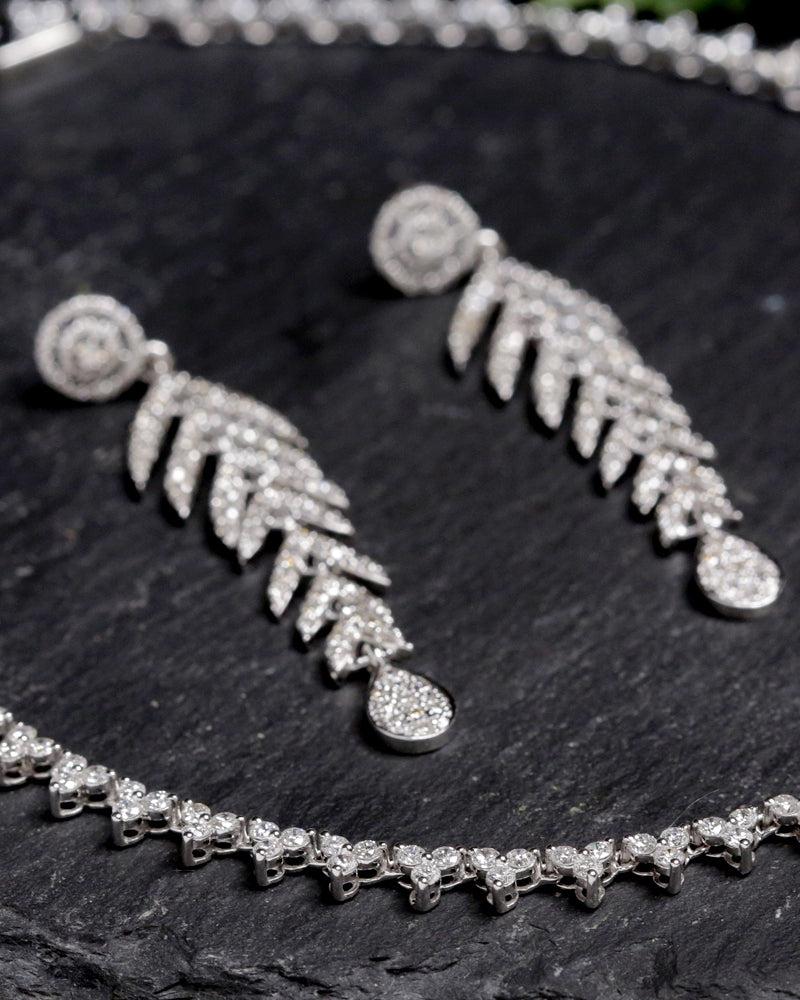 These earrings are made of 18K white gold and natural diamond. They hang down from the ear in a feather shape, making them a unique and eye-catching accessory.

Specifications:

Dimensions: 61*15 MM
Gross Weight: 12.00 gms
Gold Weight: 11.47