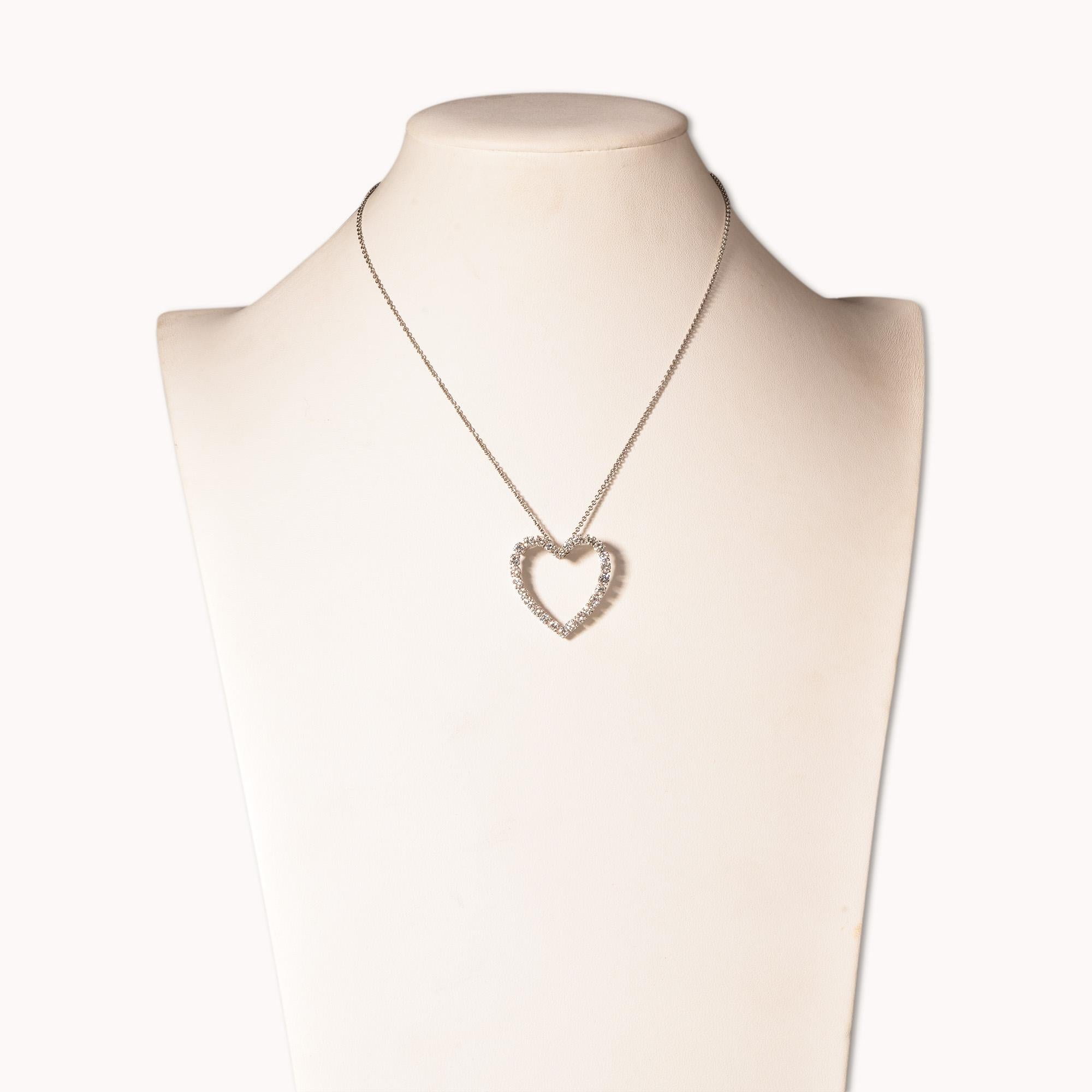 An absolutely dazzling open heart diamond pendant necklace in 14k white gold. This beautiful necklace would make an excellent anniversary or valentines day gift. 

Features 26 brilliant diamonds, each approximately .10 CT, prong-set in a timeless