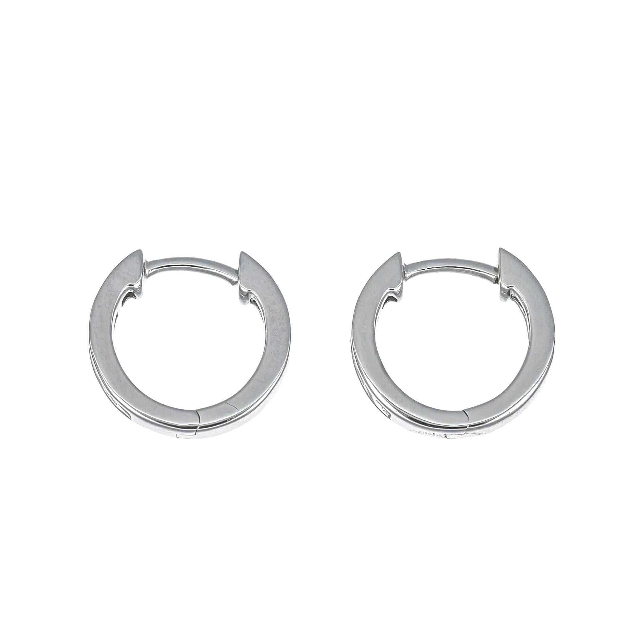Introducing the epitome of minimalistic beauty, our 18KT White Gold Princess Diamond Half Hoop Huggies with Bezel detailing are a radiant expression of refined elegance. Crafted with meticulous attention to detail, these earrings boast a simple yet