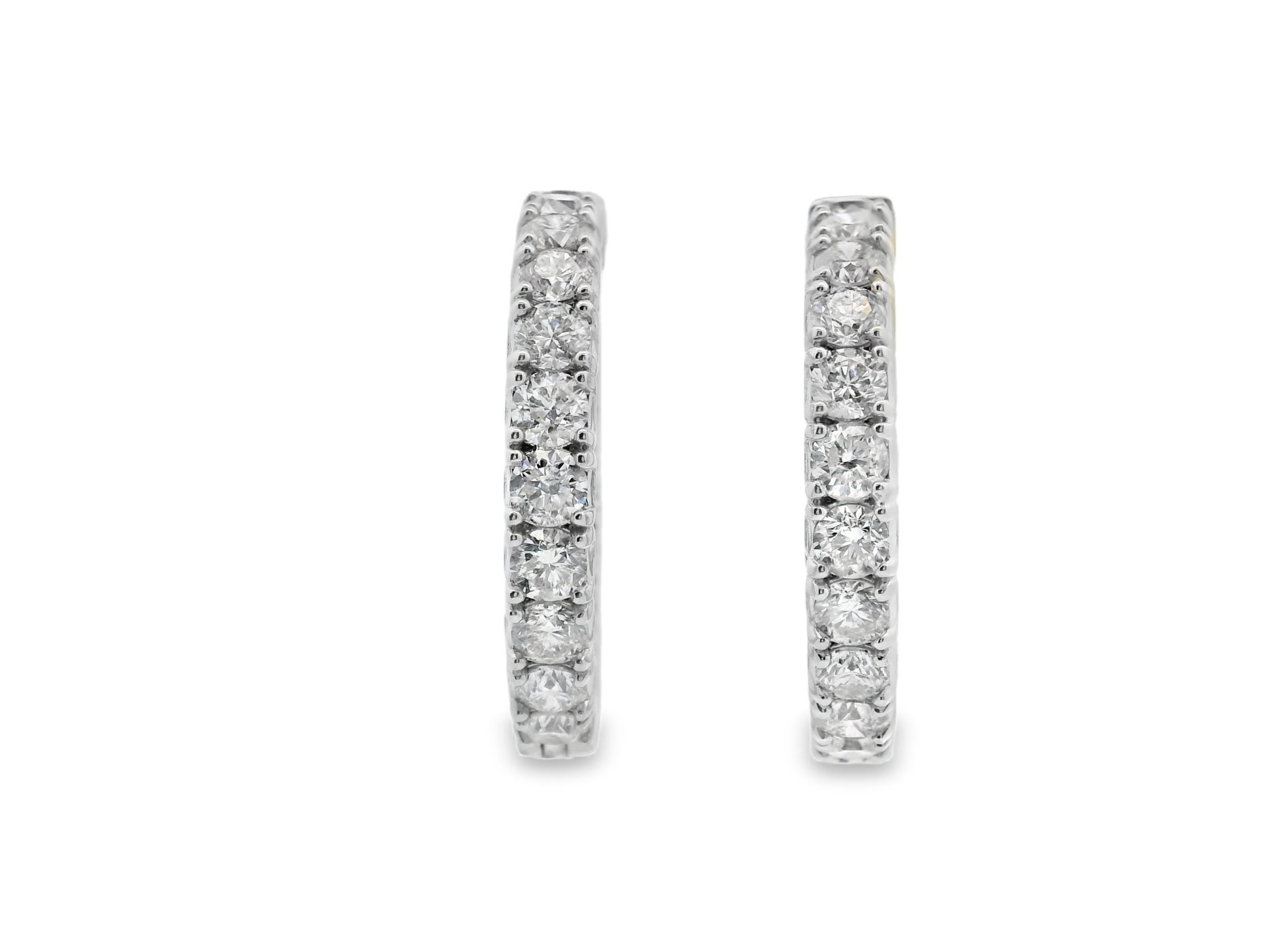 Diamond hoop earrings in 14K white gold, set with 8.50 carats of round brilliant-cut natural diamonds. These inside-out hoops offer full-circle sparkle—each of the 36 diamonds is prong-set for maximum light exposure and brilliance. Finished in