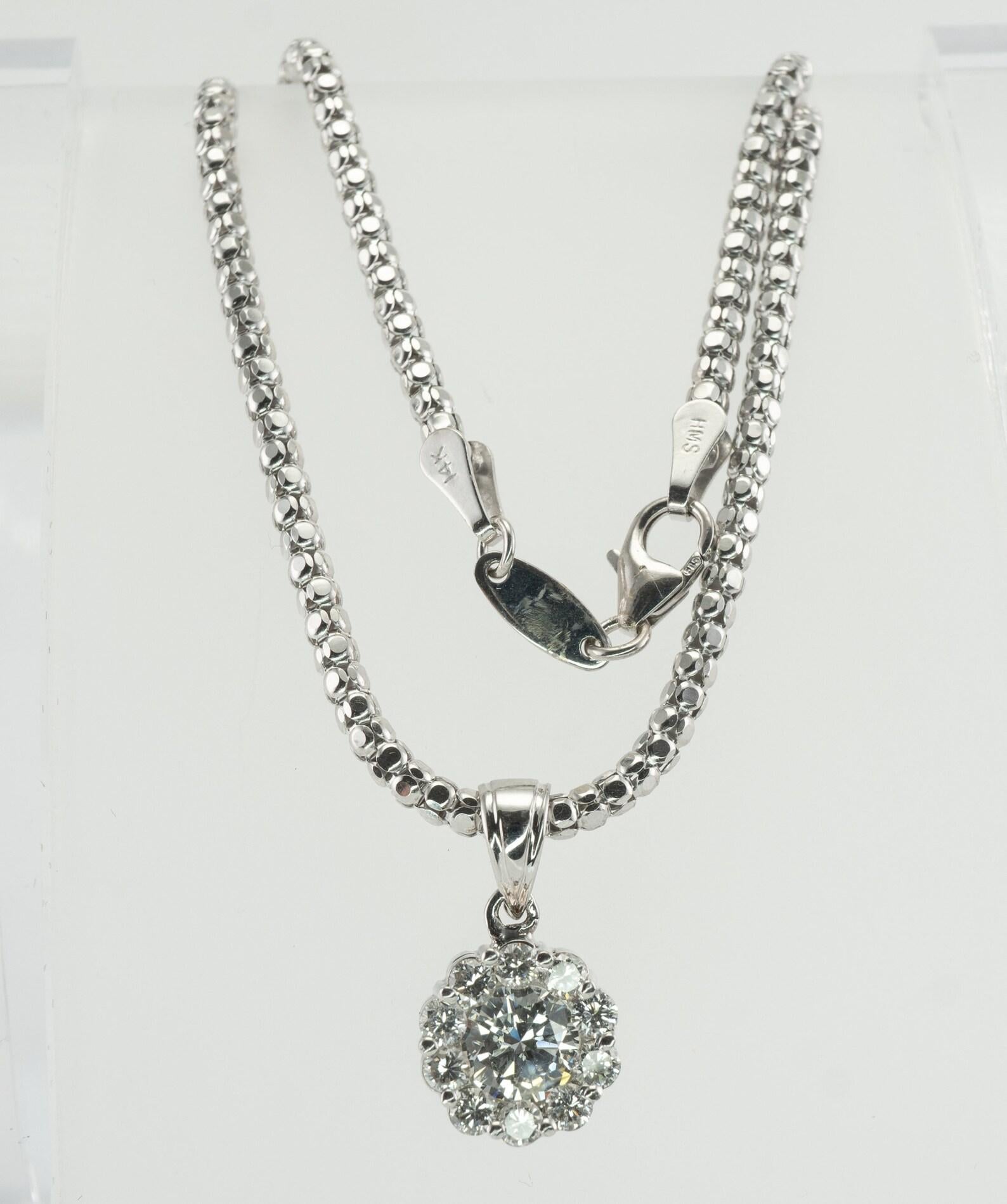 Diamond Pendant Necklace 14K White Gold 1.20 cts TDW Halo

This gorgeous estate necklace is finely crafted in solid 14K White Gold.
The center diamond is .50 carat, 10 surrounding diamonds add .70 carat.
The grand total for the pendant is 1.20