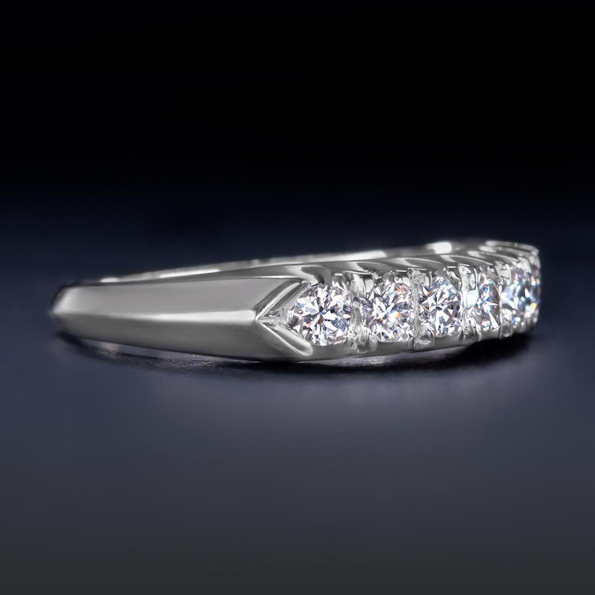 This elegant and high quality wedding band has a stunning display of vibrant sparkle! The seven round brilliant cut diamonds are bright white, completely eye clean, and vibrant with lively brilliance! The refined platinum setting is satisfyingly