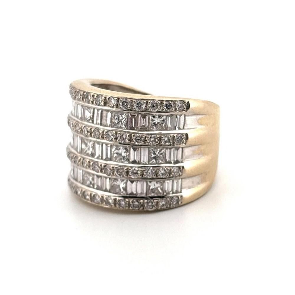 This substantial and brilliantly designed band ring is crafted in solid 14K white gold and weighs an impressive 14.14 grams. The top of the ring features a wide 16mm face with a 7mm shank, showcasing an intricate layout of seven rows of diamonds.