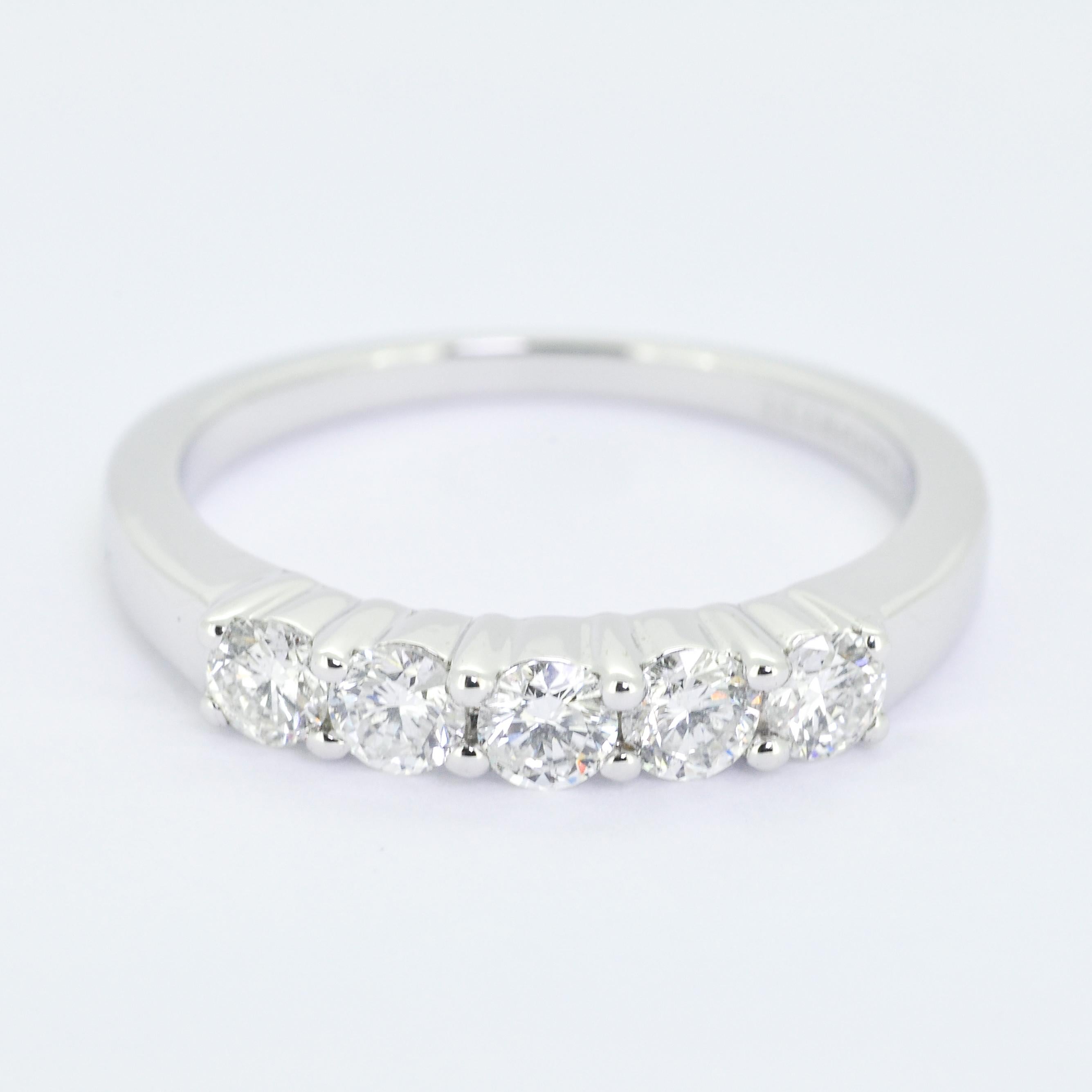 Crafted with precision and passion, this stunning piece features five brilliant diamonds, totaling 0.51 carats, set in an 18-karat white gold band.

The simplicity of the design enhances the ring's overall allure, making it a perfect symbol of