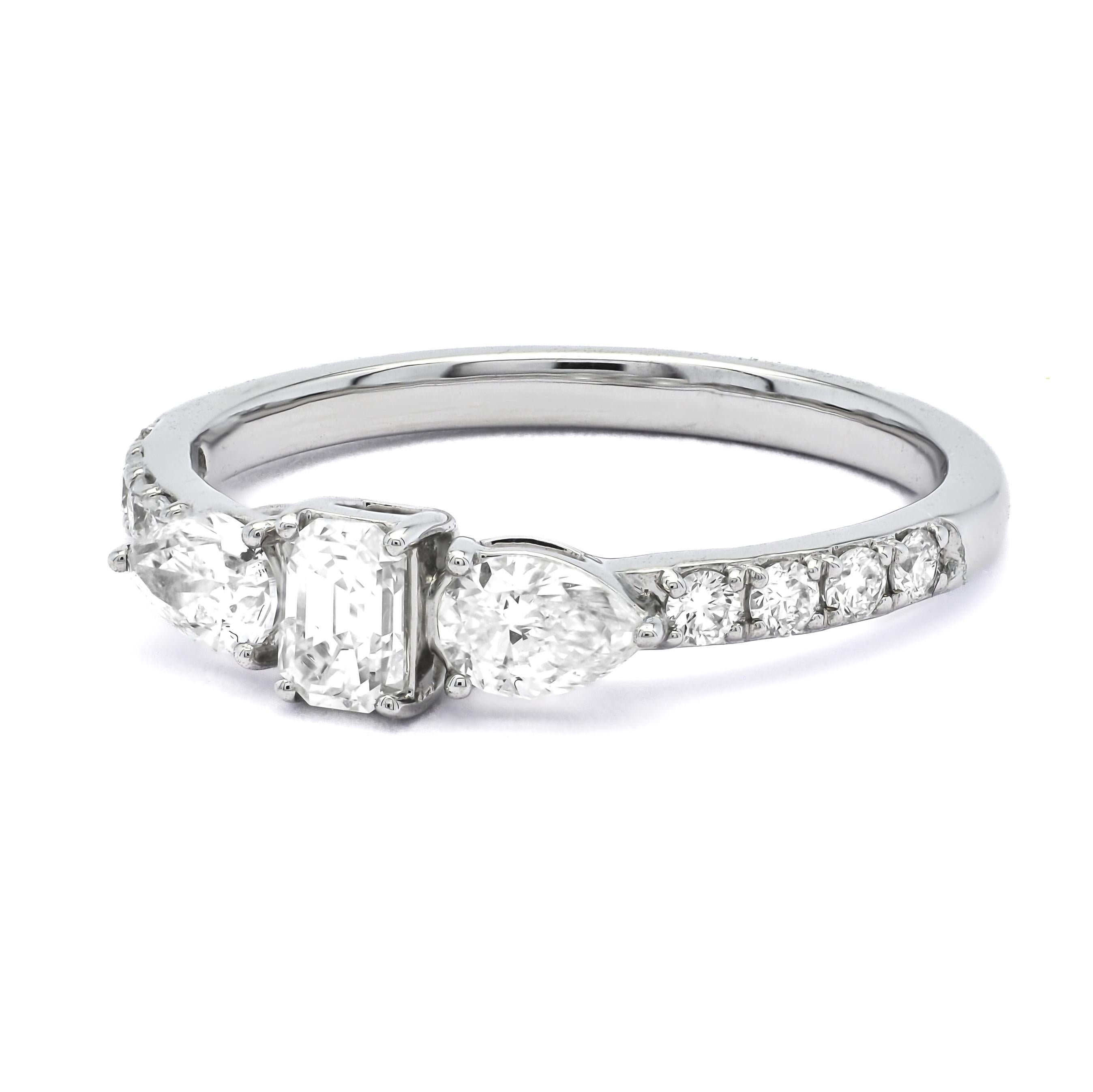 Introducing the epitome of timeless sophistication, behold the exquisite solitaire engagement ring featuring a mesmerizing middle baguette-shaped diamond and two gracefully adorning pear-shaped diamonds on either side. 
At the heart of this