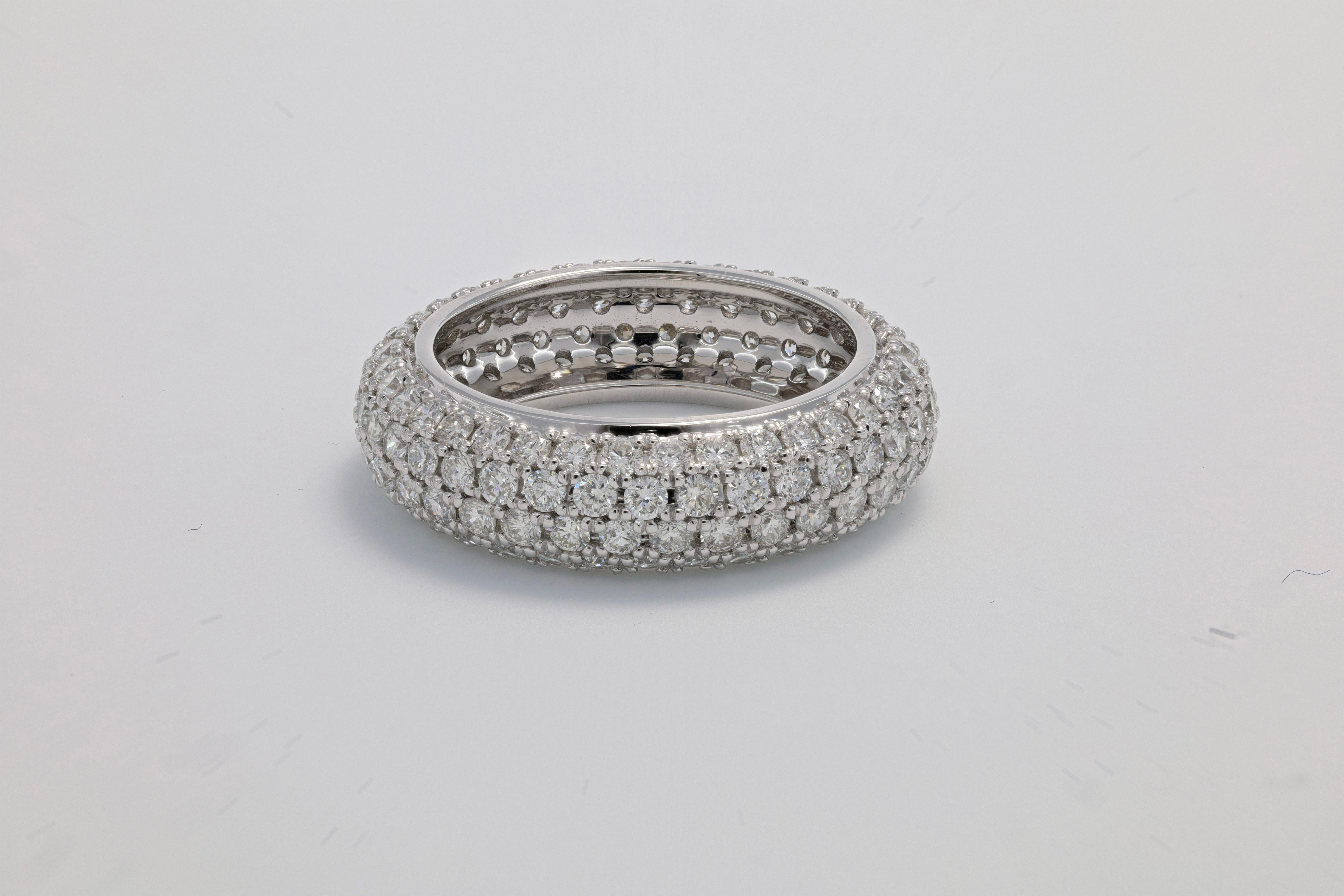 This exquisite ring showcases a dazzling display of opulence, adorned with a remarkable 2.83 carats of diamonds that captivate the beholder with their radiant brilliance. The meticulous craftsmanship is evident in the expert arrangement of these