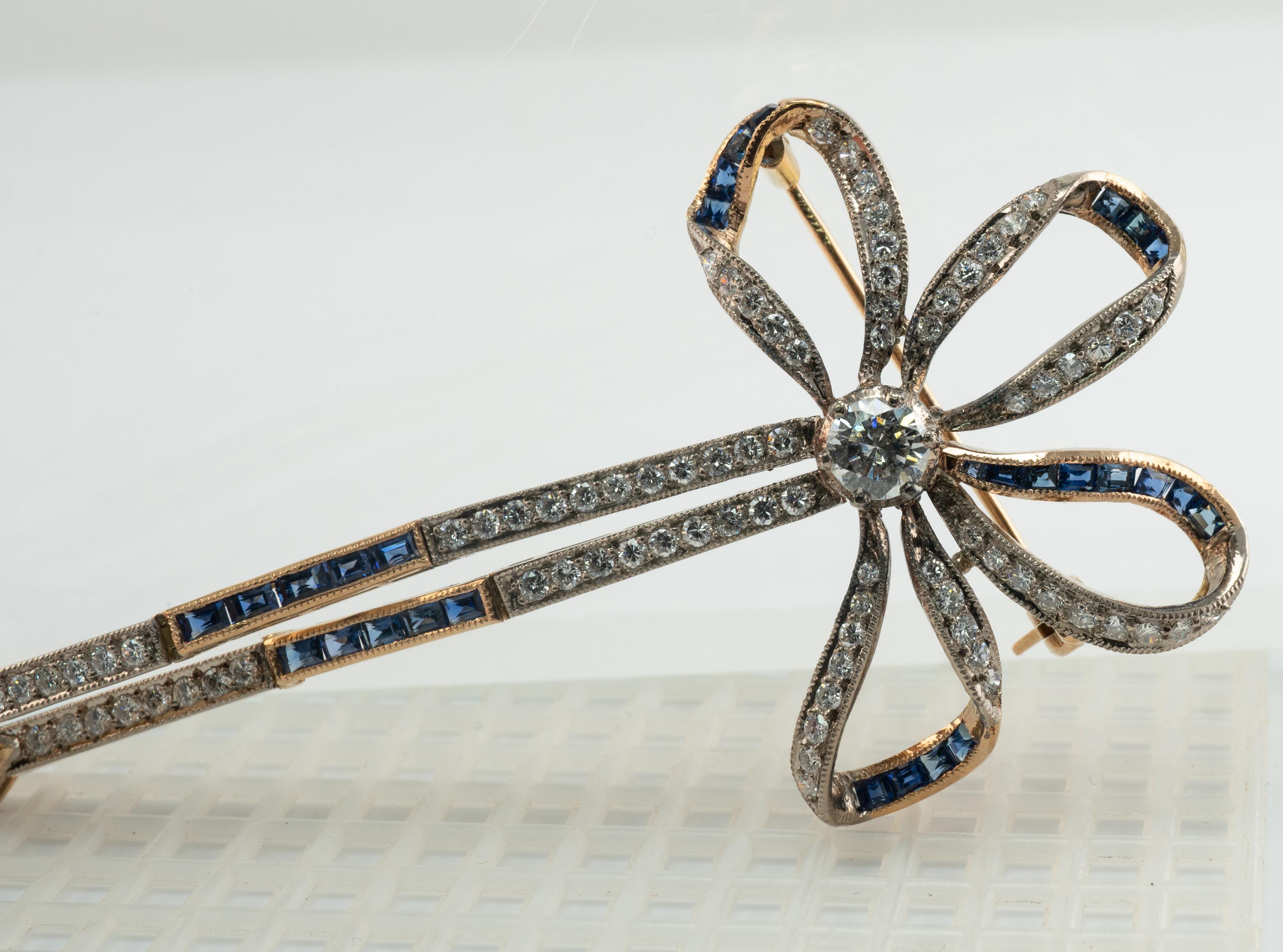 Natural Diamond Sapphire Pearl Brooch Bow Ribbon 18K Gold Vintage

This gold brooch is finely crafted in solid 18K Yellow gold (carefully tested and guaranteed). 
The center diamond is .40 carat of VS2 clarity and H color.
87 smaller diamonds total