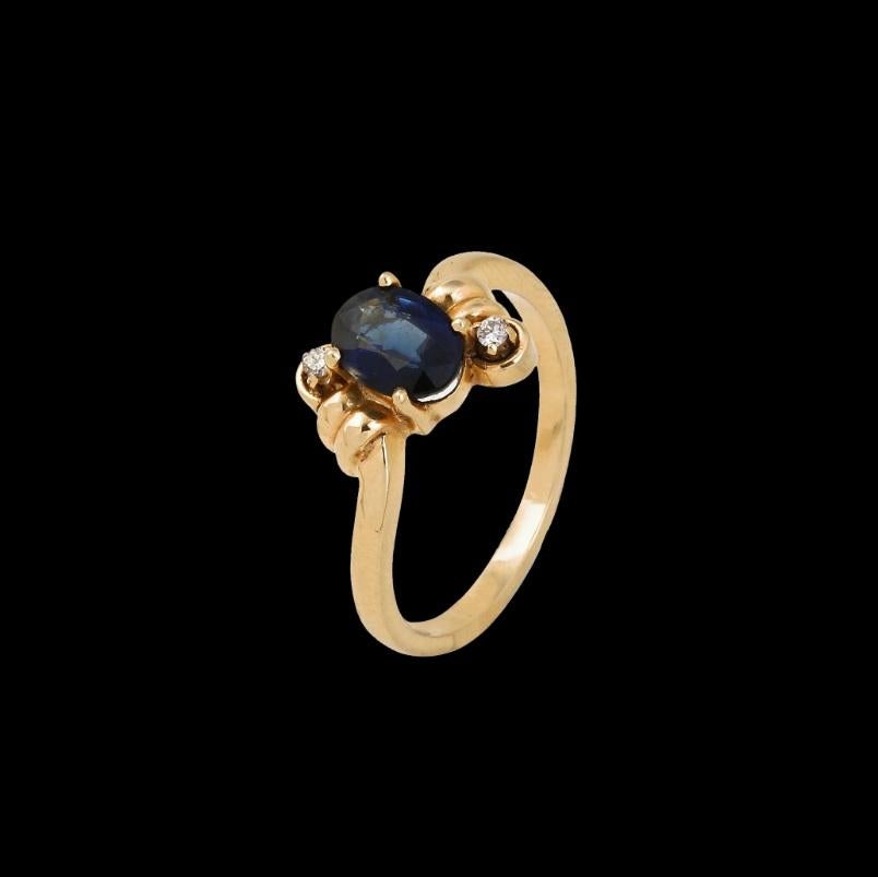 Questo anello è realizzato in oro giallo massiccio 14K e incastonato con una gemma naturale di diamante e zaffiro. Il diamante è di taglio rotondo e ha un peso totale di 0,10 carati, mentre lo zaffiro è di taglio ovale e ha un peso totale di 0,50