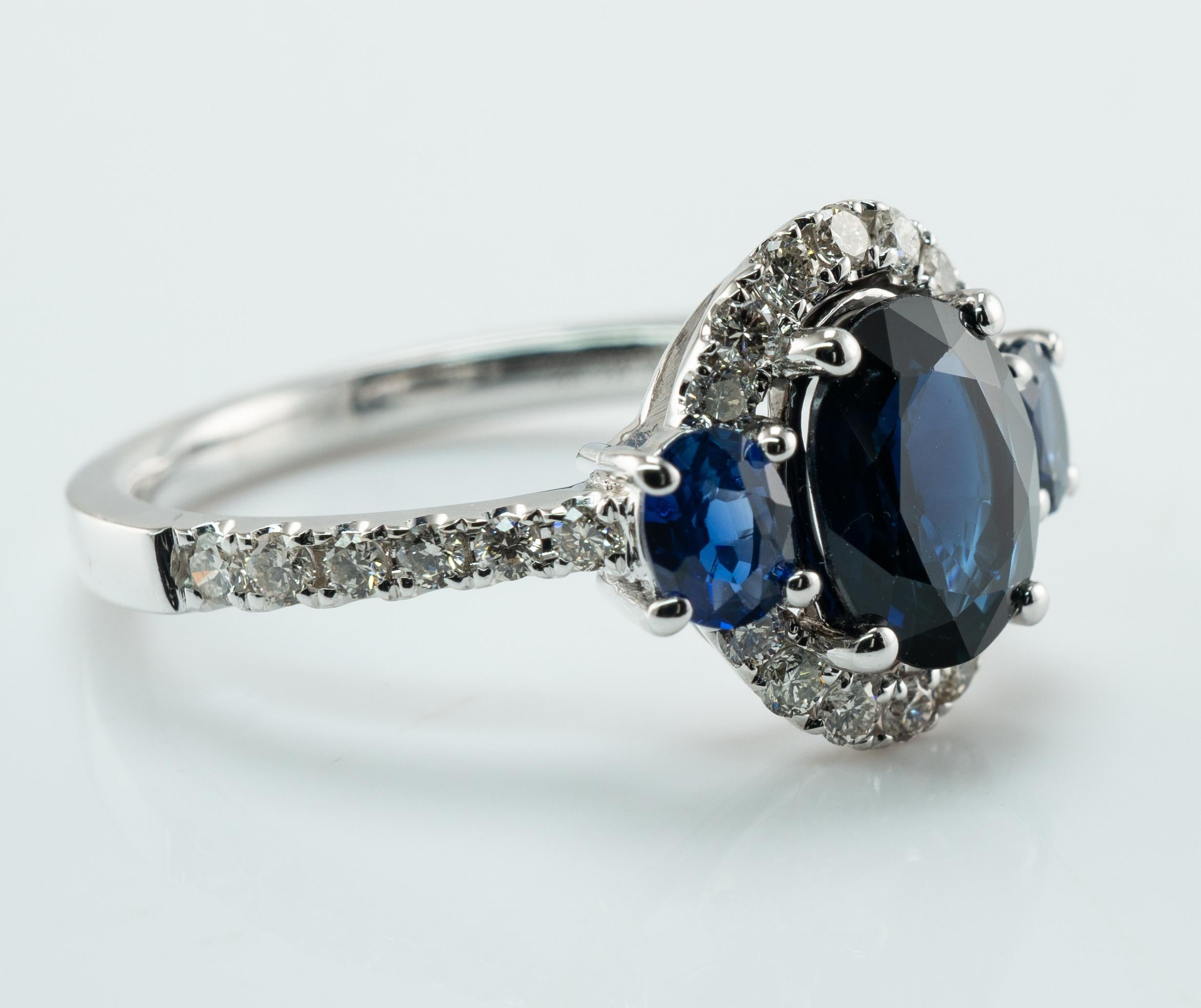 Natural Diamond Sapphire Ring 14K White Gold Band Halo

This lovely estate ring is finely crafted in solid 14K White Gold and set with genuine Earth mined Sapphires and white and fiery diamonds. 
The center oval cut Sapphire measures 8x6mm (1.55
