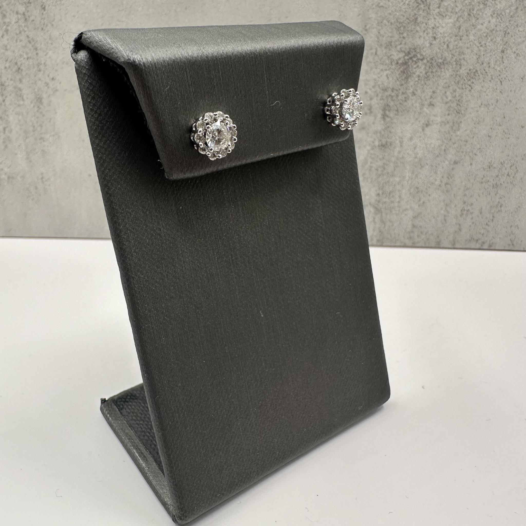These exquisite Natural Diamond Stud Earrings in 14kt White Gold feature 0.97 carat total weight (ctw) of natural HI color, SI2-I1 clarity eye-clean round diamonds set in a classic 4-prong martini setting. The earrings come with removable jackets,