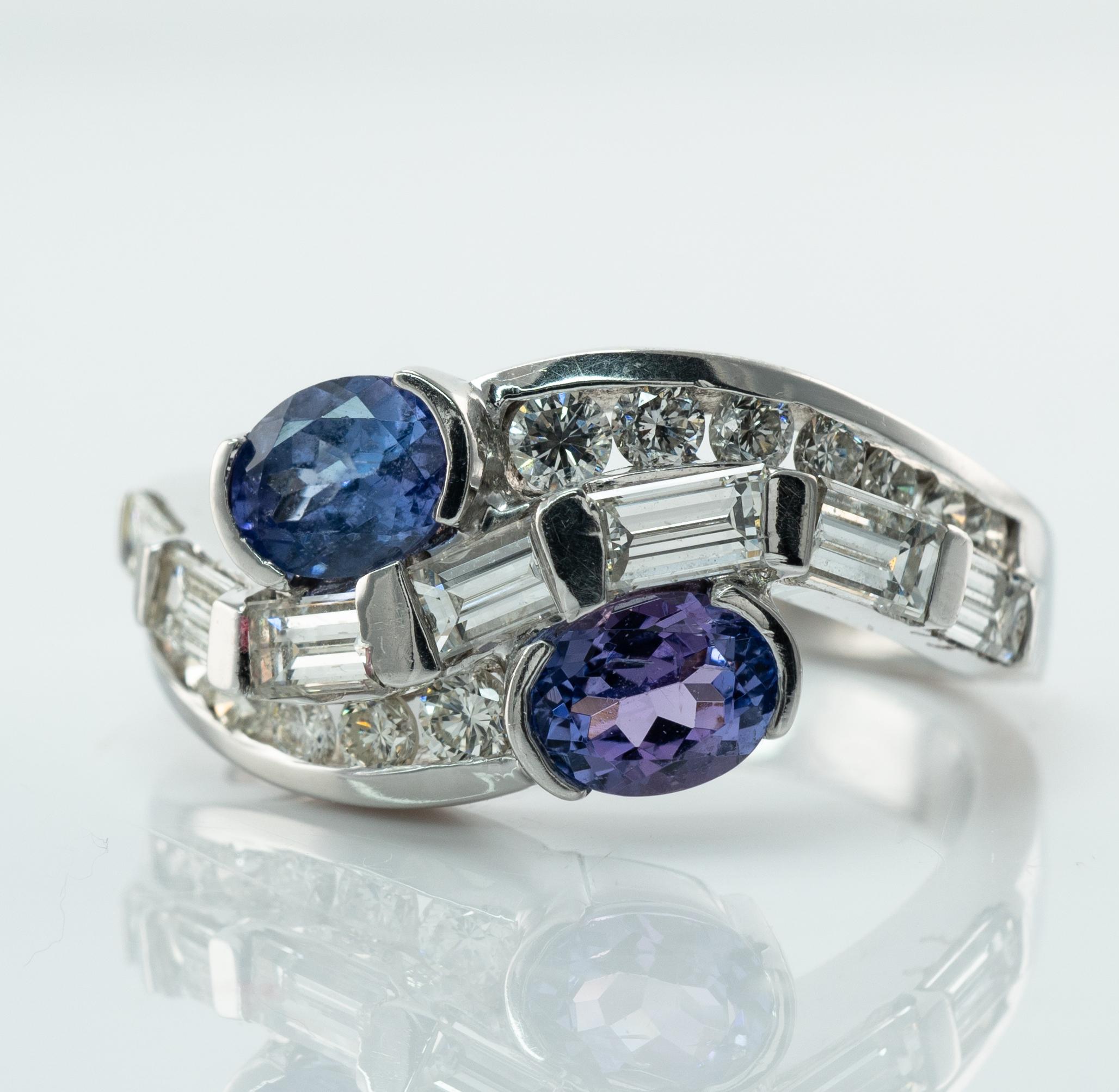 Natural Diamond Tanzanite Ring Band 14K White Gold

This beautiful estate ring is finely crafted in solid 14K White gold and set with genuine Earth mined Tanzanites and diamonds.
Two oval Tanzanites measure 5x4mm (about .40ct each) = .80 carat.
They