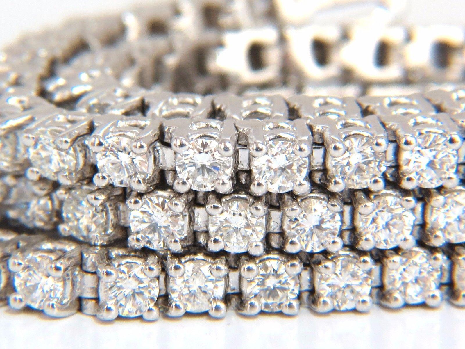 Classic Three Row.

12.32ct. natural diamonds Tennis Bracelet.

Rounds, Full cut brilliants

147 Diamonds

G colors Vs-2 clarity

14kt. white gold

38.7 Grams.

7 Inches long (wearable length)

10mm wide

pressure clasp and safety catch 

Appraisal