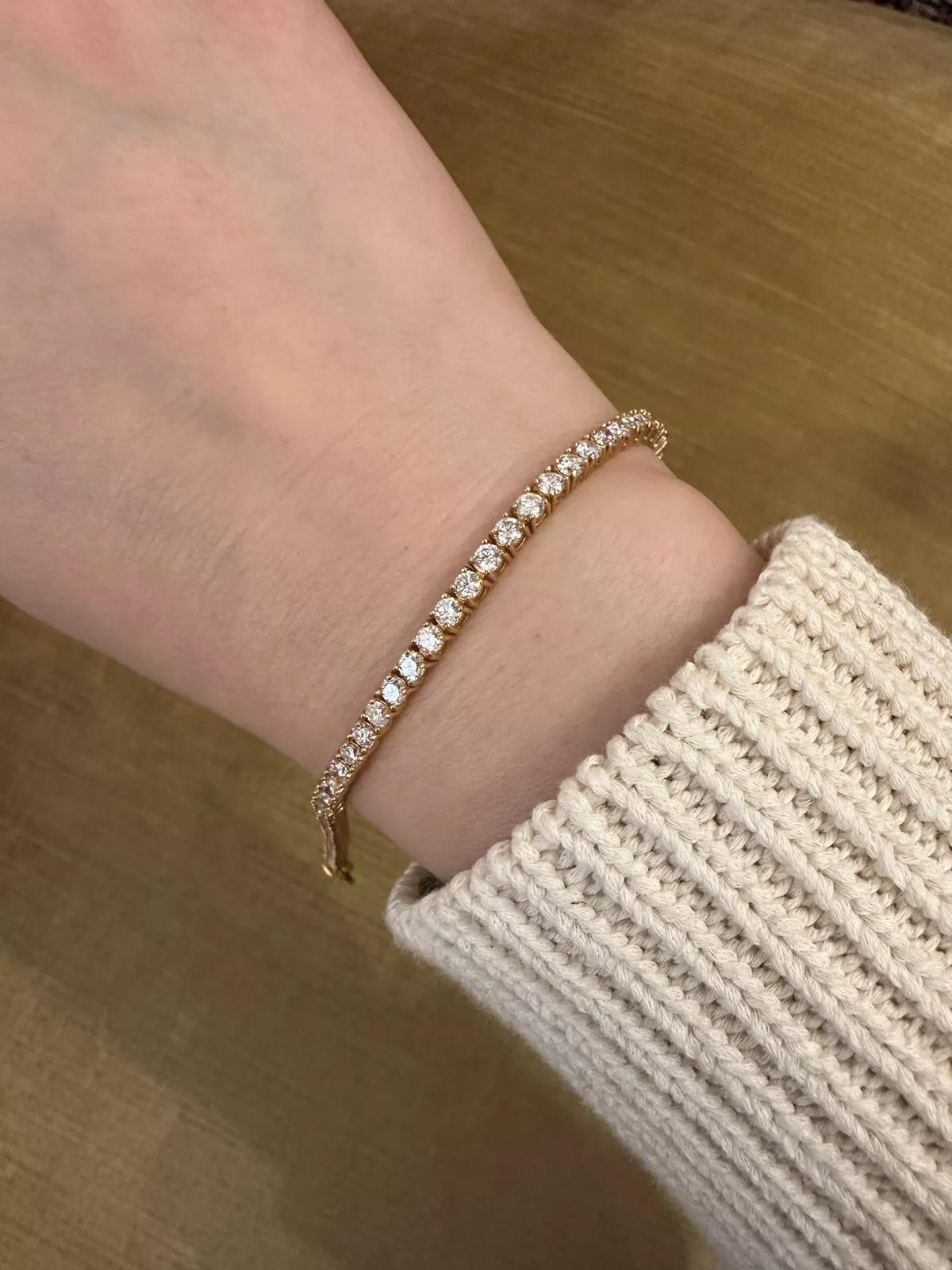 Natural Diamond Tennis Bracelet 5.28 carat total weight 8 inch in 14k Yellow Gold

Diamond Bracelet features 64 Natural Round Diamonds totaling 5.28 carats set in 14k Yellow Gold. The tennis bracelet is secured by a box clasp with safety