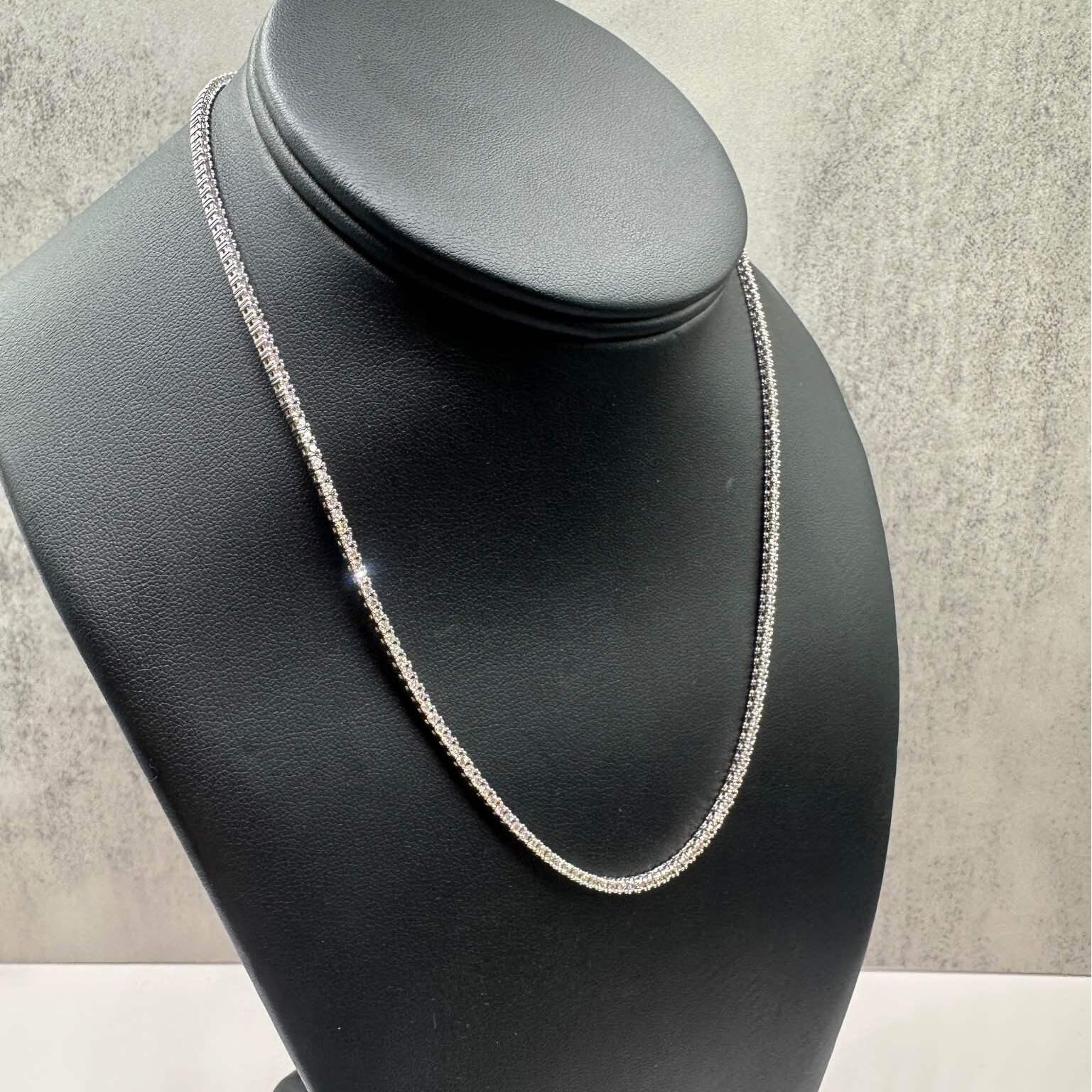 This stunning Natural Diamond Tennis Necklace in 14kt white gold features 3.23ctw of natural GH SI round diamonds, offering brilliant sparkle with every movement. With a length of 16 inches, this necklace sits perfectly on the neckline, making it