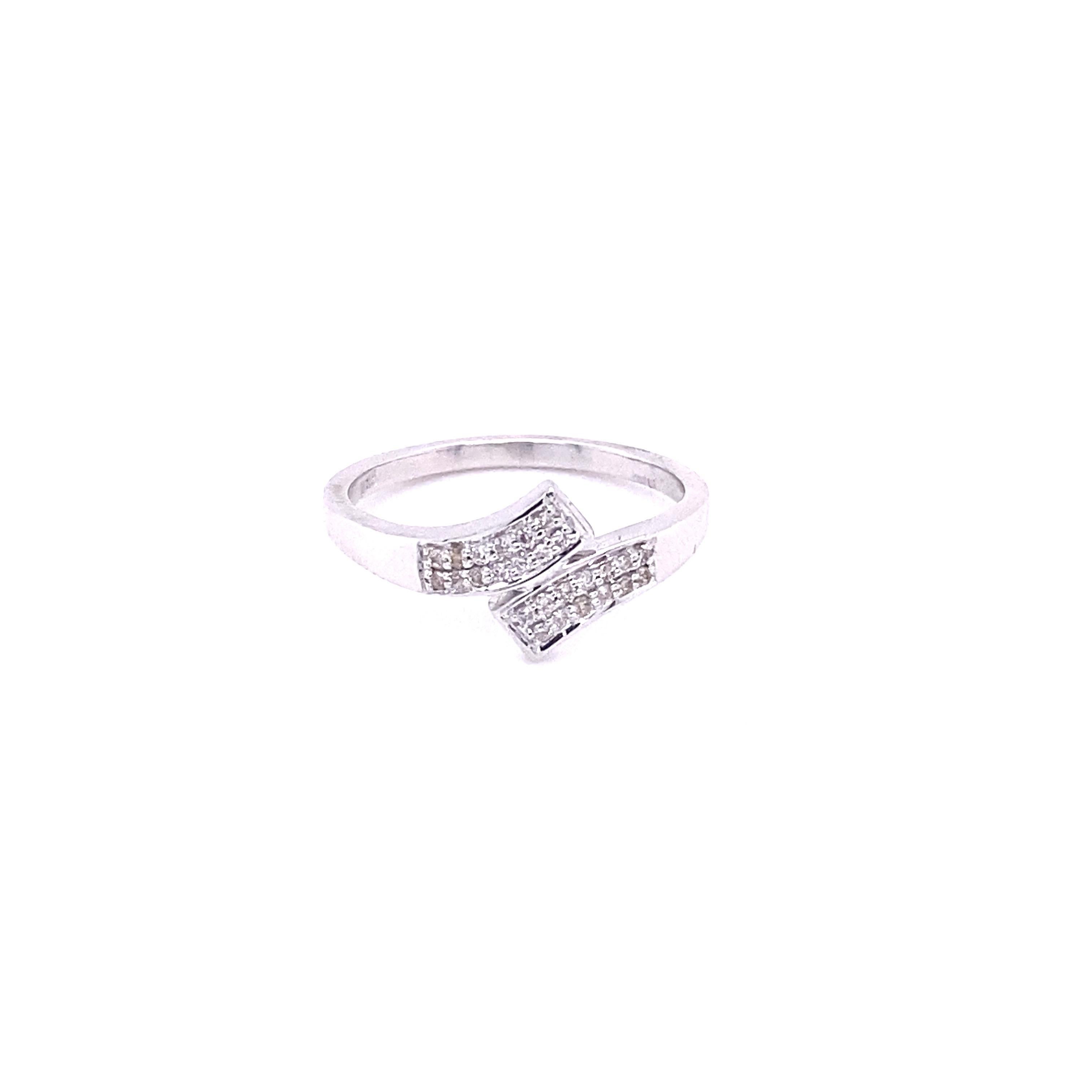 A bypass shank and some natural diamonds can change the entire appearance of the night! This diamond ring is made in 14k white gold and set with beautiful white round diamonds in a prong style setting! A very petite ring for a grand night! You can