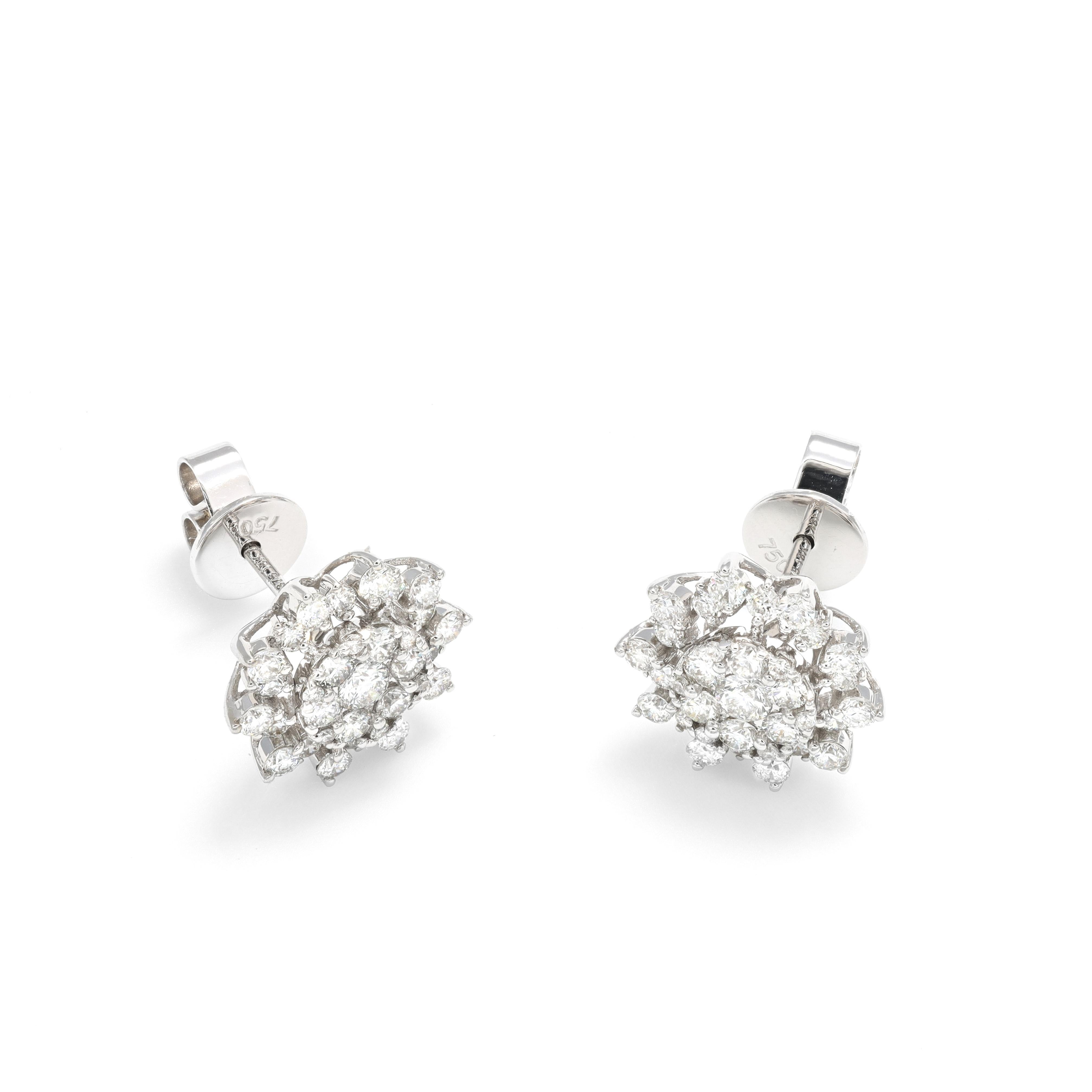 Introducing our stunning Diamonds Flower Shape Cluster Setting Studs, a perfect combination of simplicity and elegance. These Natural Diamond Earrings in 18KT White Gold feature a cluster of diamonds in a captivating flower shape setting, creating a